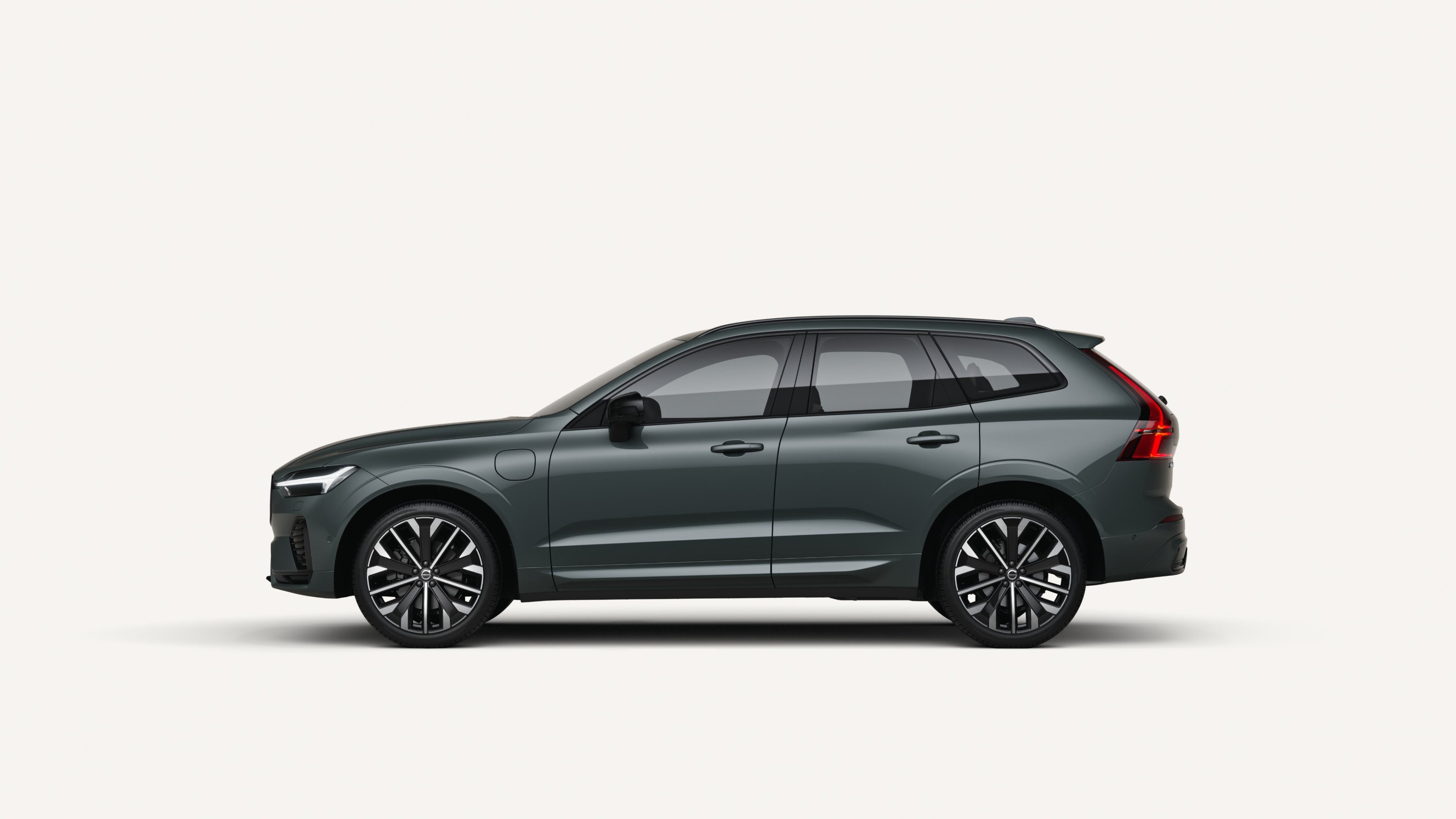 Side view of the Volvo XC60 plug-in hybrid in a white studio environment.