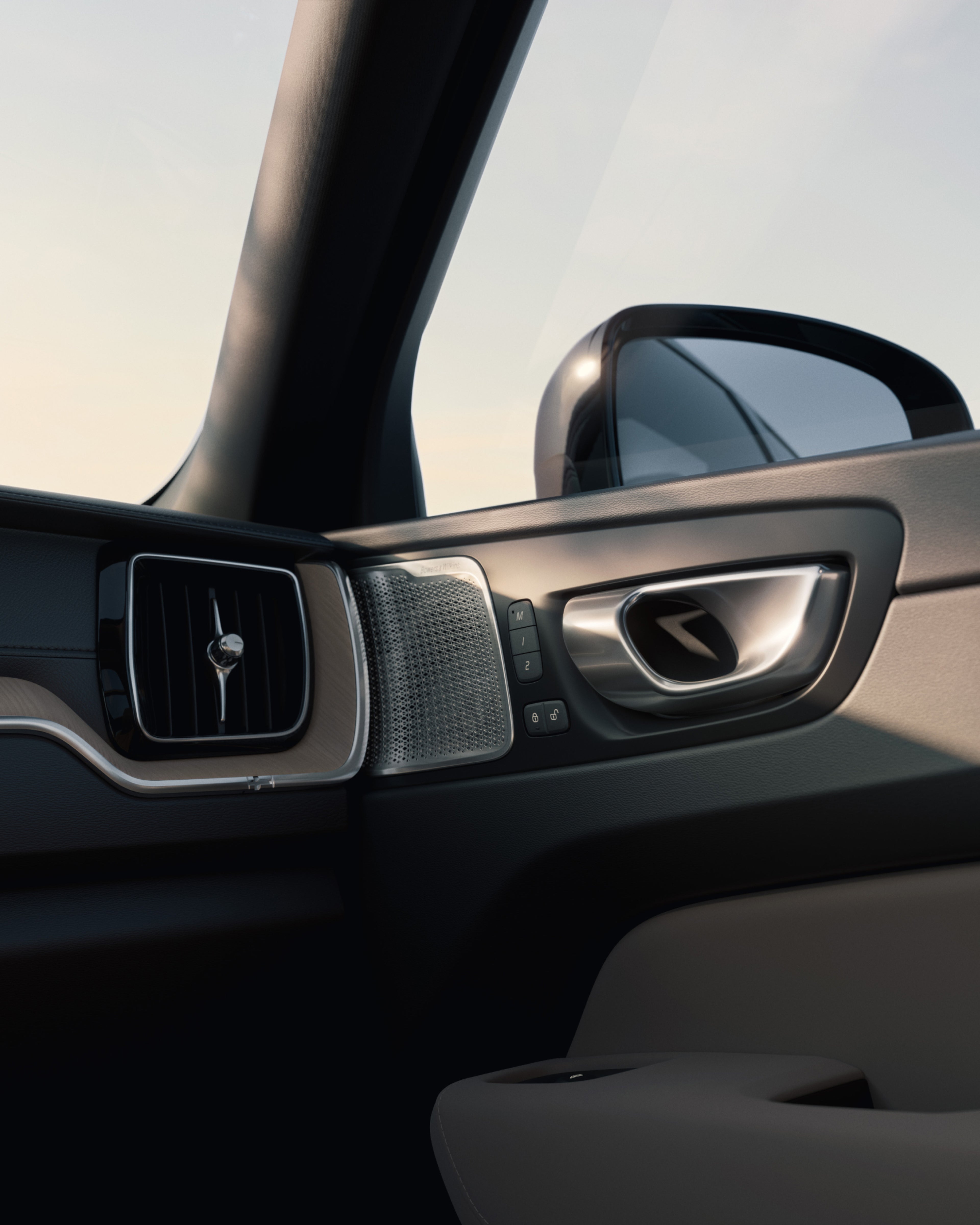 Close-up of the Volvo XC60 interior detailing, highlighting the Bowers & Wilkins speaker with metallic grille.