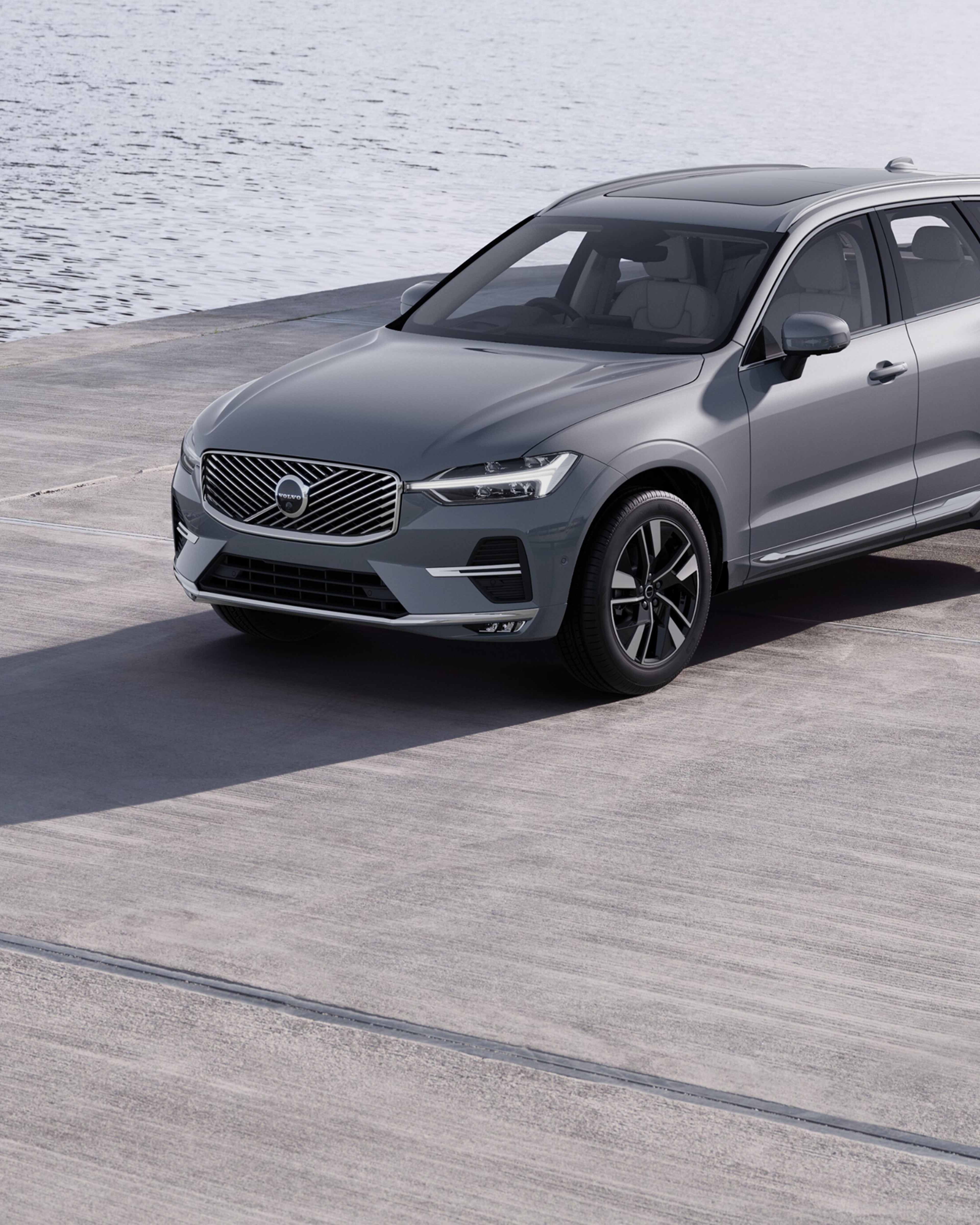 The grille and Volvo Iron Mark of a Volvo XC60 mild-hybrid SUV.