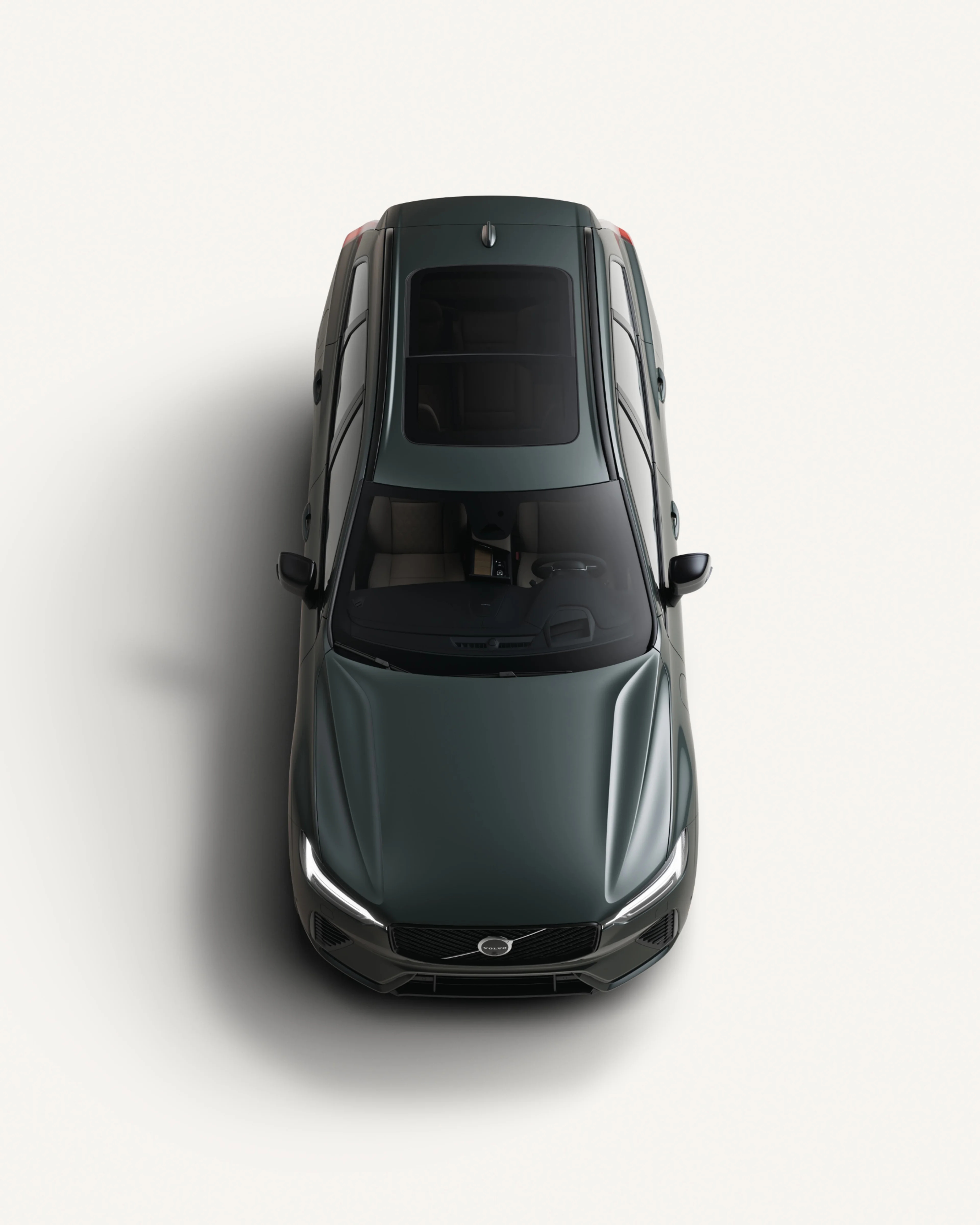 Bird’s-eye view of the Volvo XC60 midsize plug-in hybrid SUV in a white studio environment.