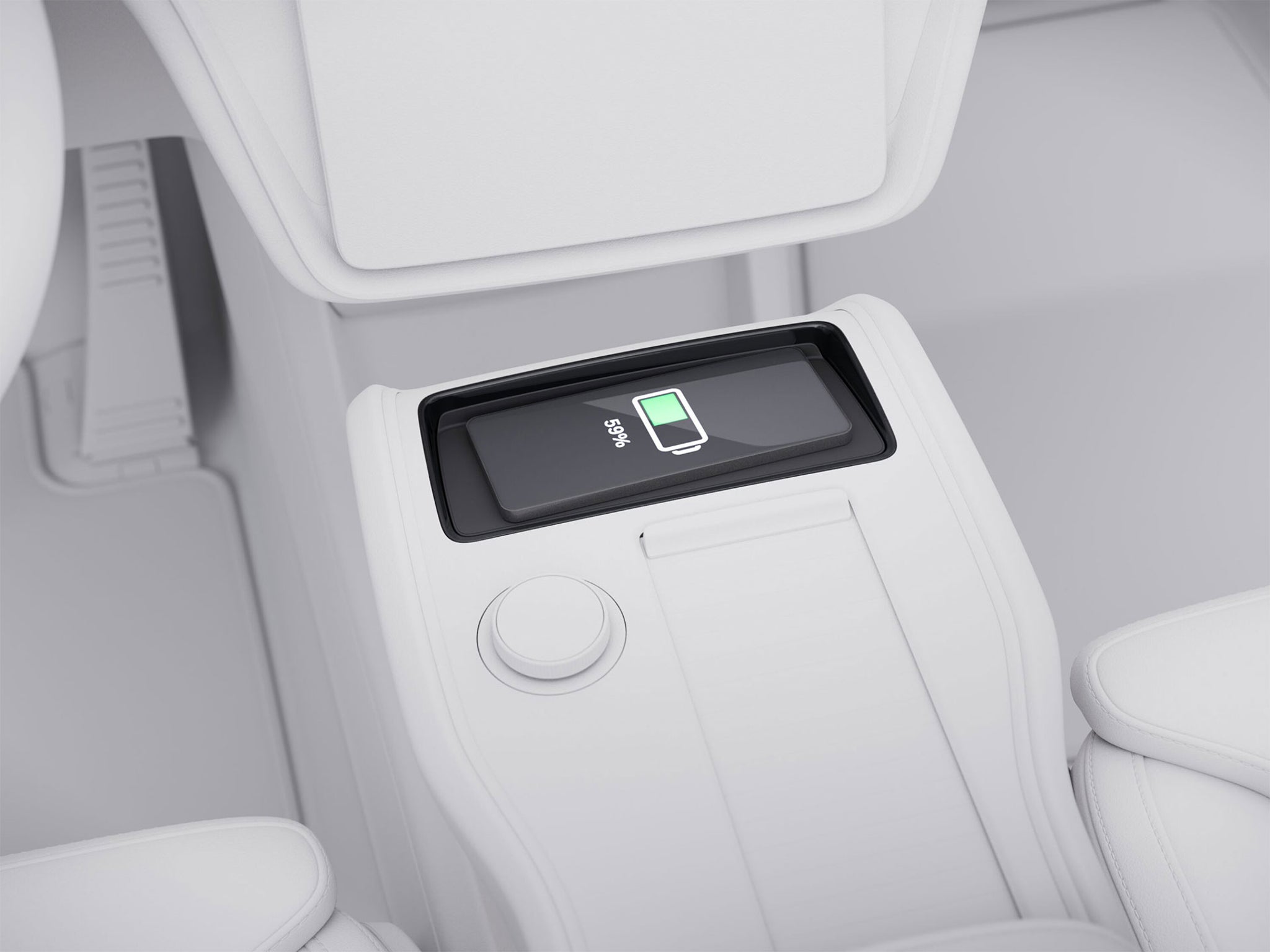 The Volvo EX90’s centre console, focusing in on a smartphone that is charging on the dedicated wireless charging pad.