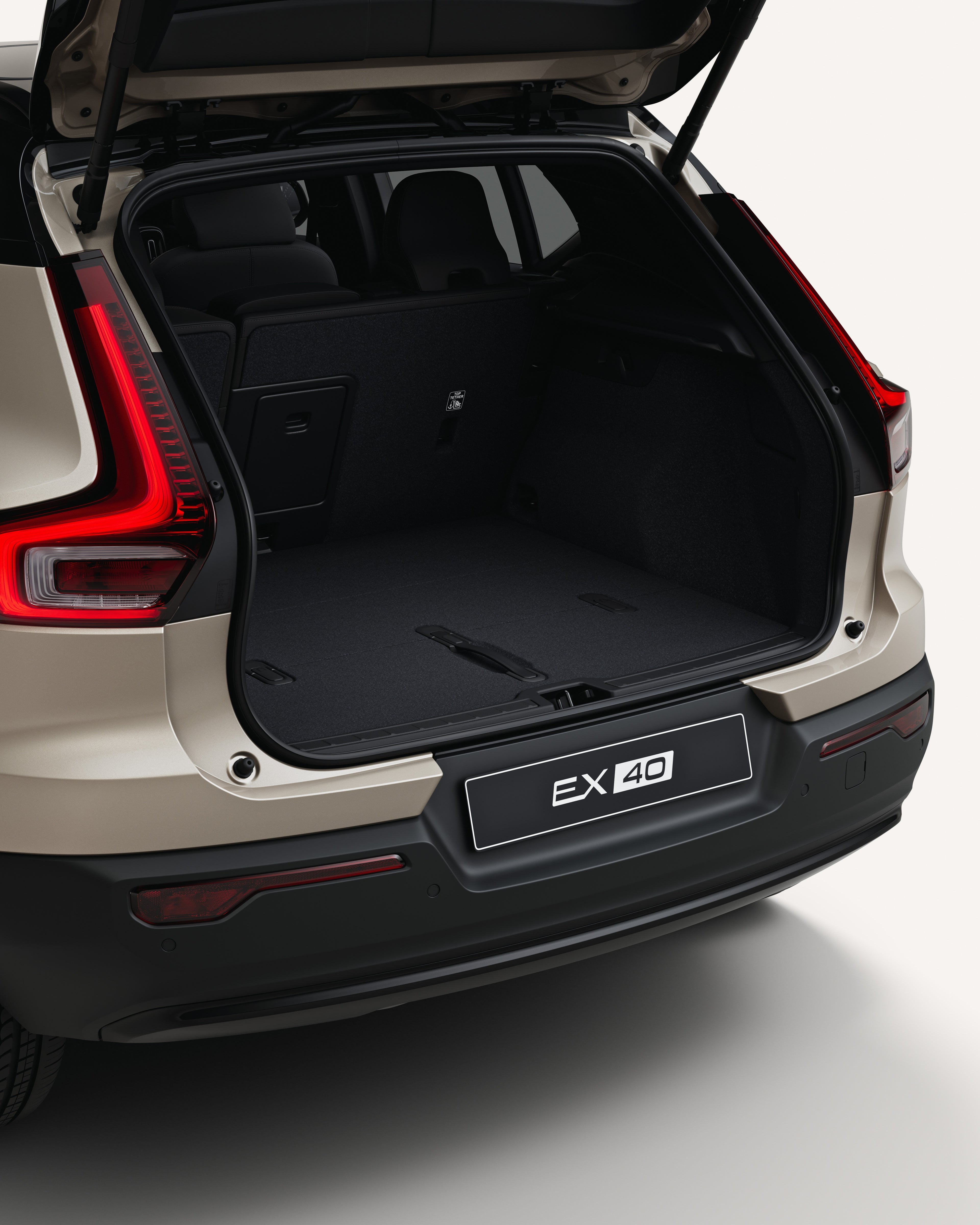 Angled rear view of the Volvo EX40 with an open trunk