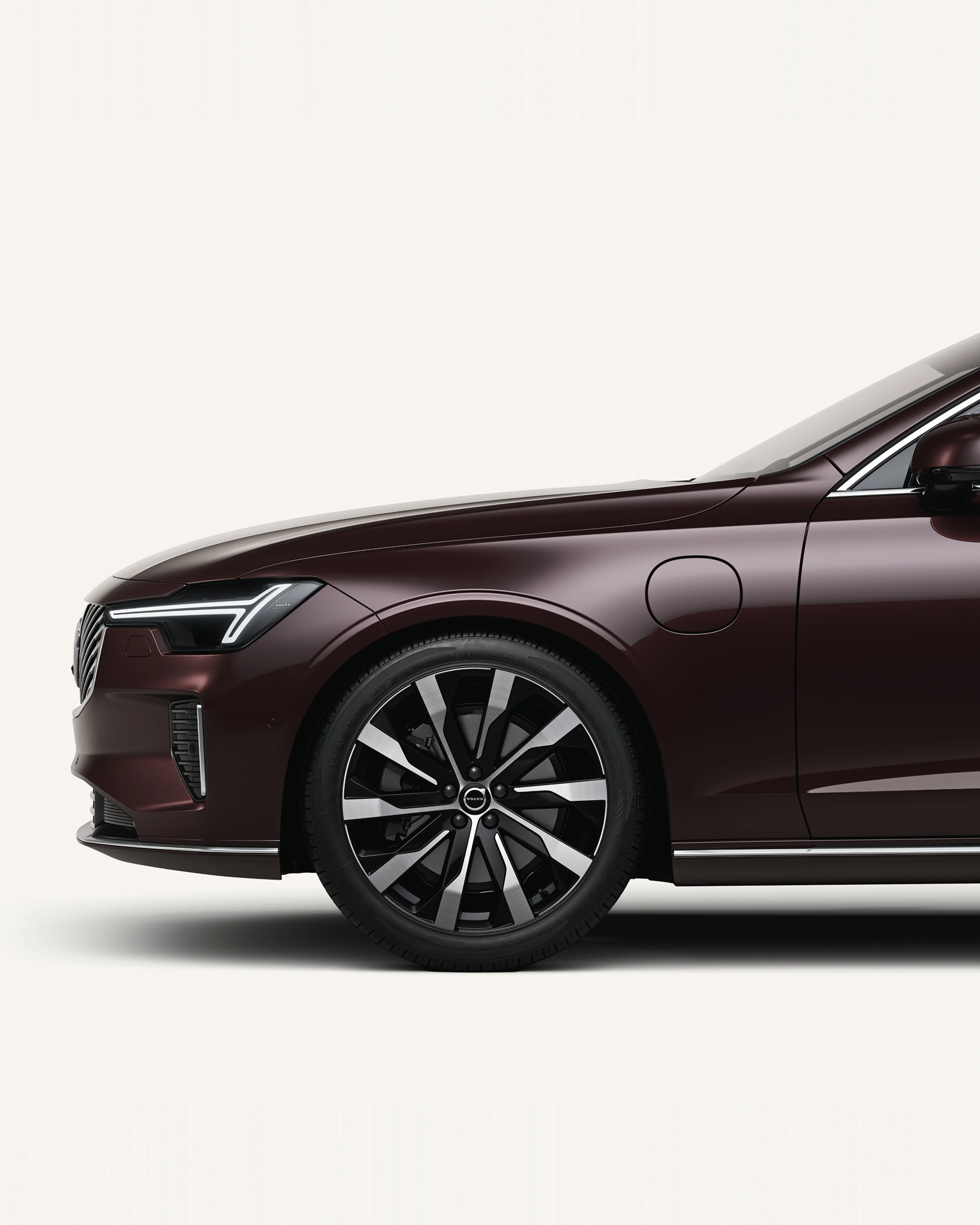Front half of the Volvo S90 in a white studio environment.