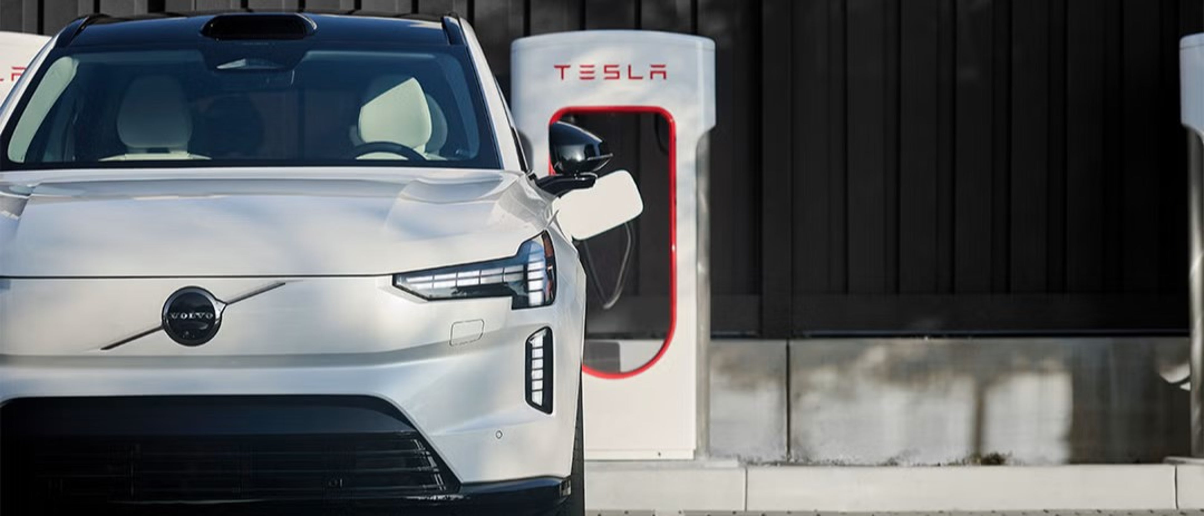 Volvo plugged into a charger compatible with NACS.