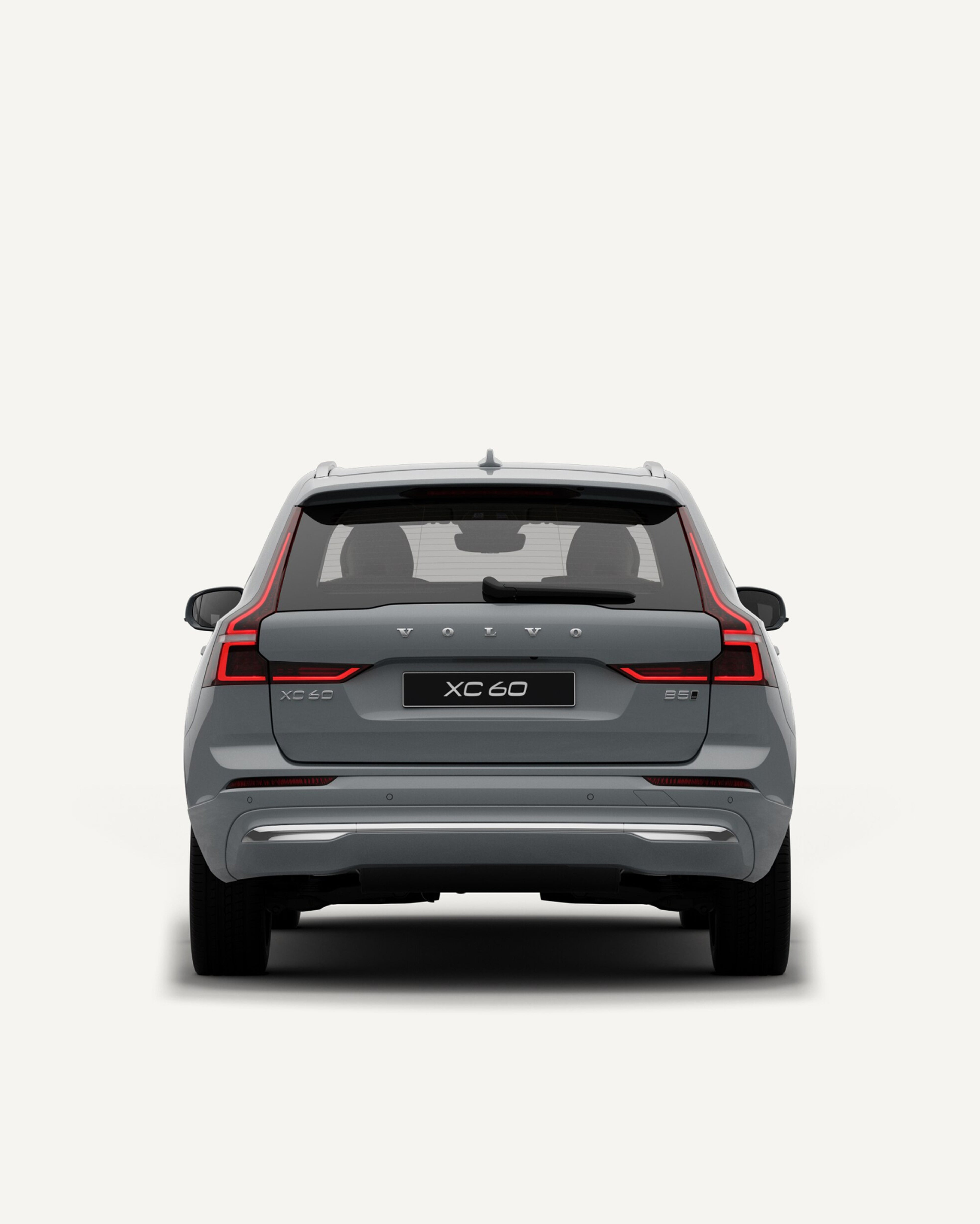 Rear view of the Volvo XC60 midsize mild-hybrid SUV in a white studio environment.