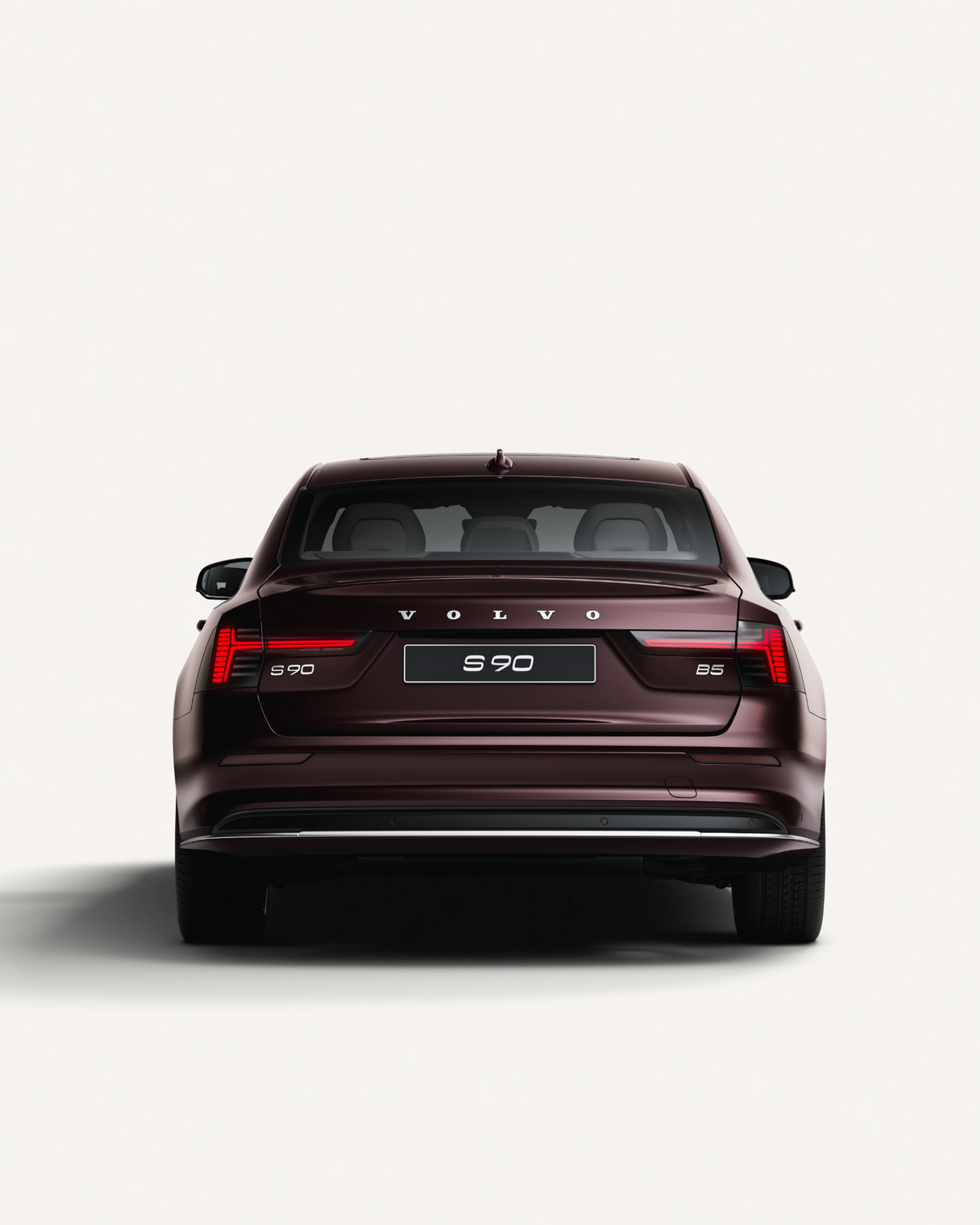 Rear view of the Volvo S90 in a white studio environment.