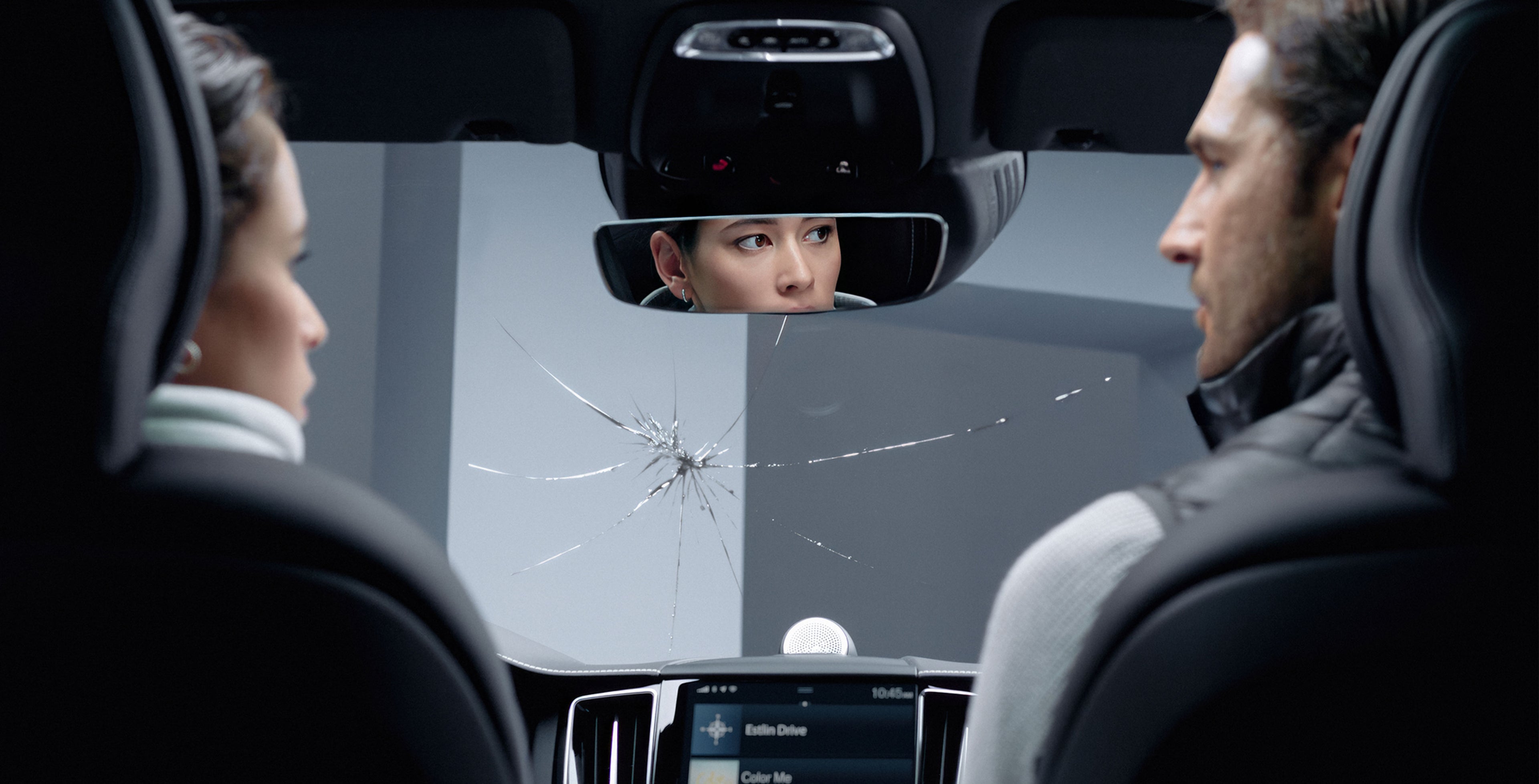 Autossa istuvat nainen ja mies ihmettelevät tuulilasissa näkyvää isoa säröä.