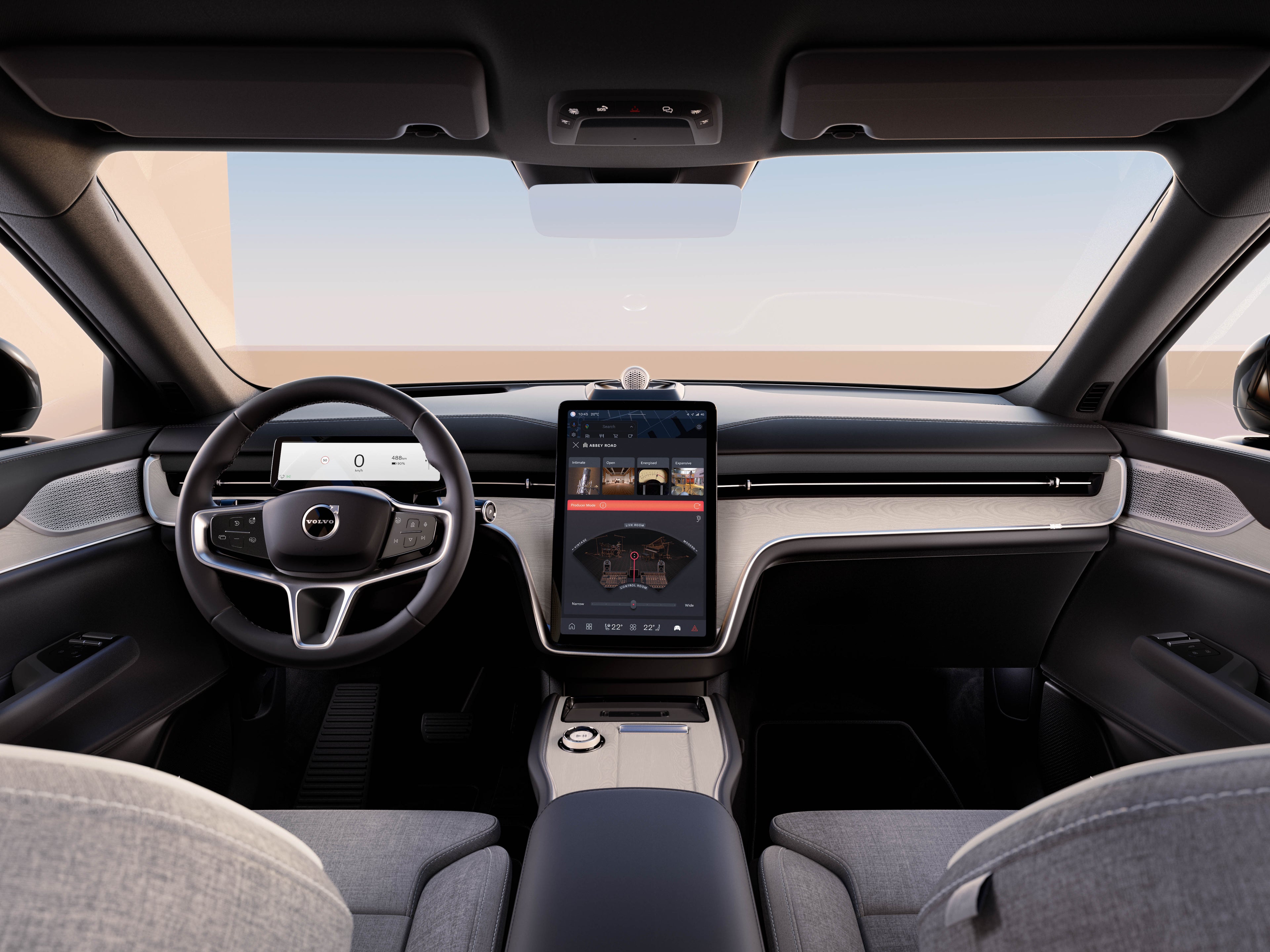 صورة من الداخل لـVolvo EX90 تظهر عجلة القيادة، وشاشة العرض الرقمية للسائق، والشاشة المركزية التي تعمل باللمس مع واجهة Abbey Road Studios.