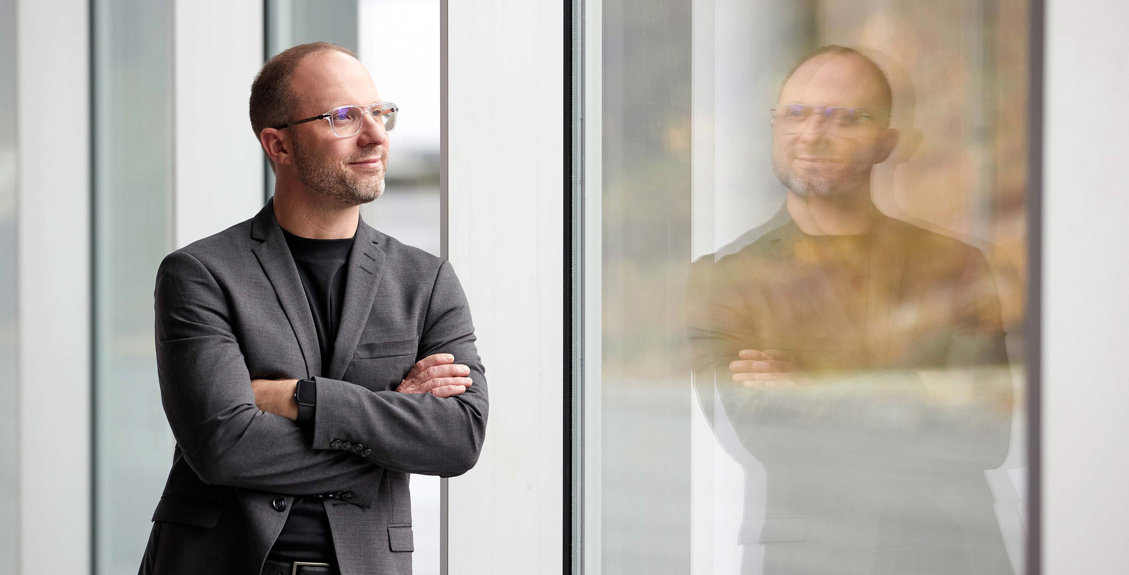 Designer T. Jon Meyer looking outside a window.