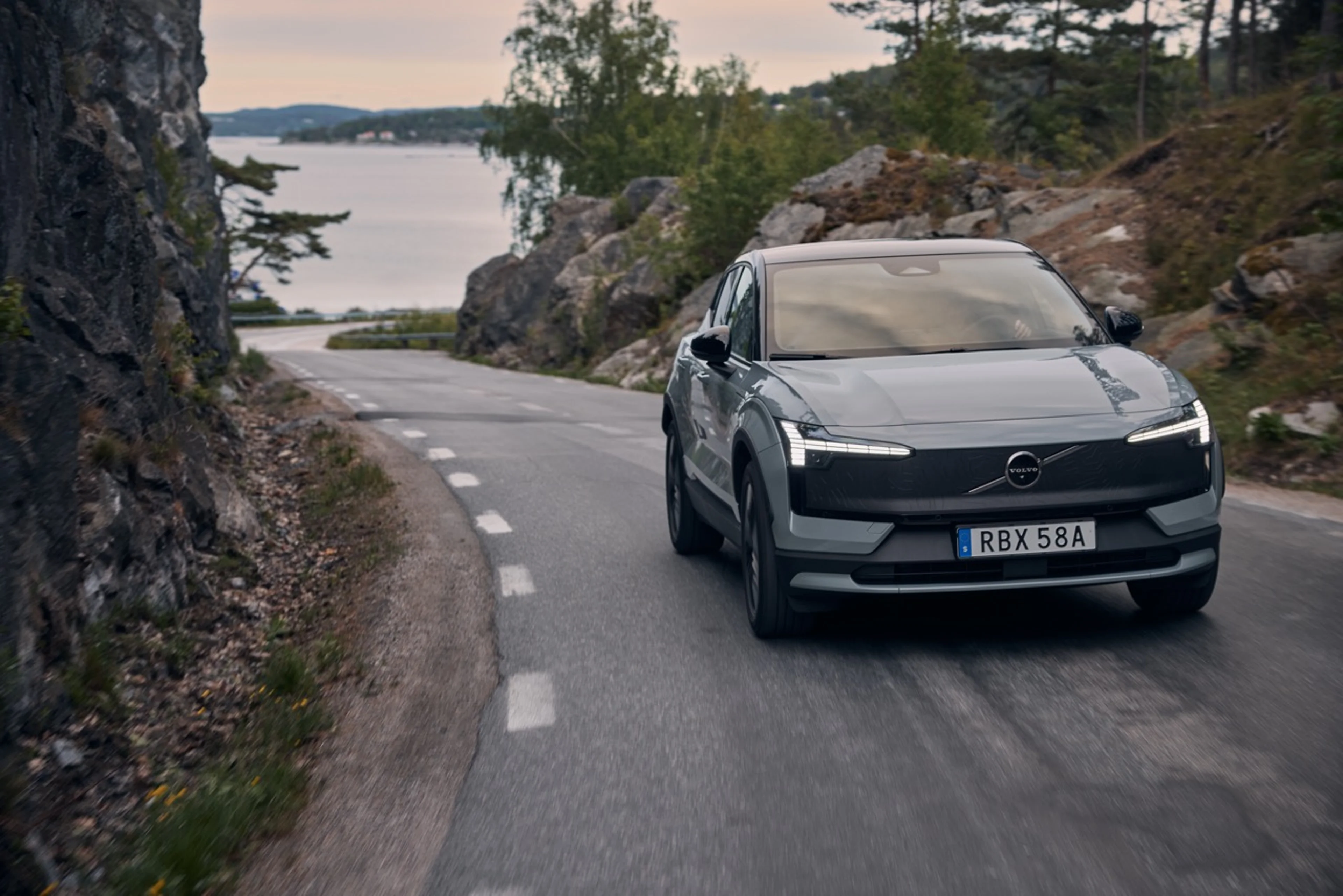 EX30 Cross Country driving on a Swedish country road with sea in the distance