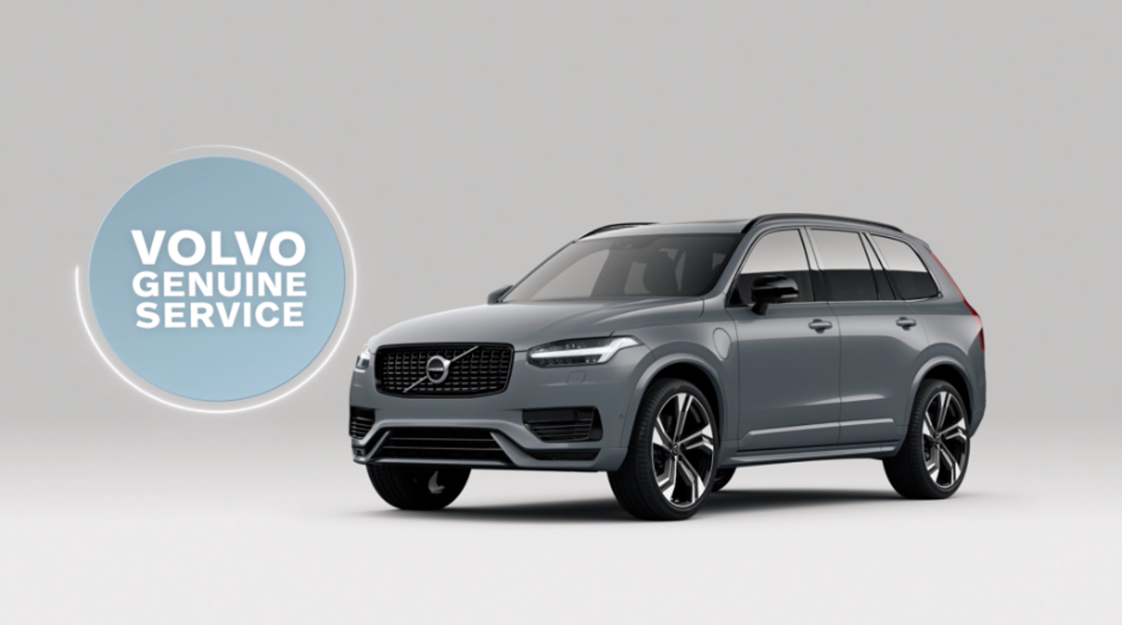Volvo genuine service logo next to Volvo car