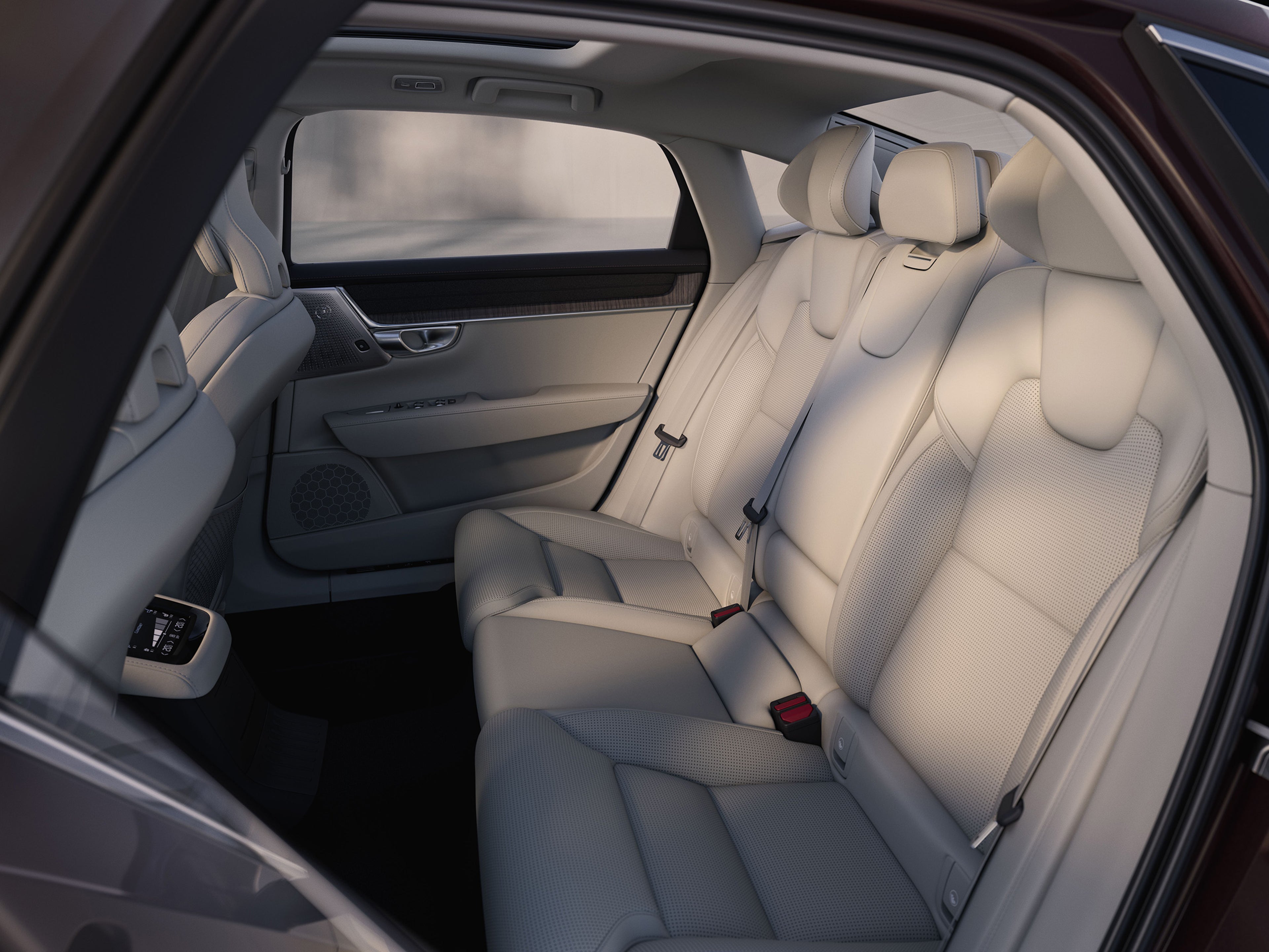 Rear passenger seats of 2025 Volvo S90 plug in hybrid featuring white leather upholstery and ample legroom.