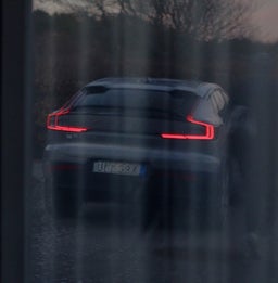 A Volvo car parked outside a window