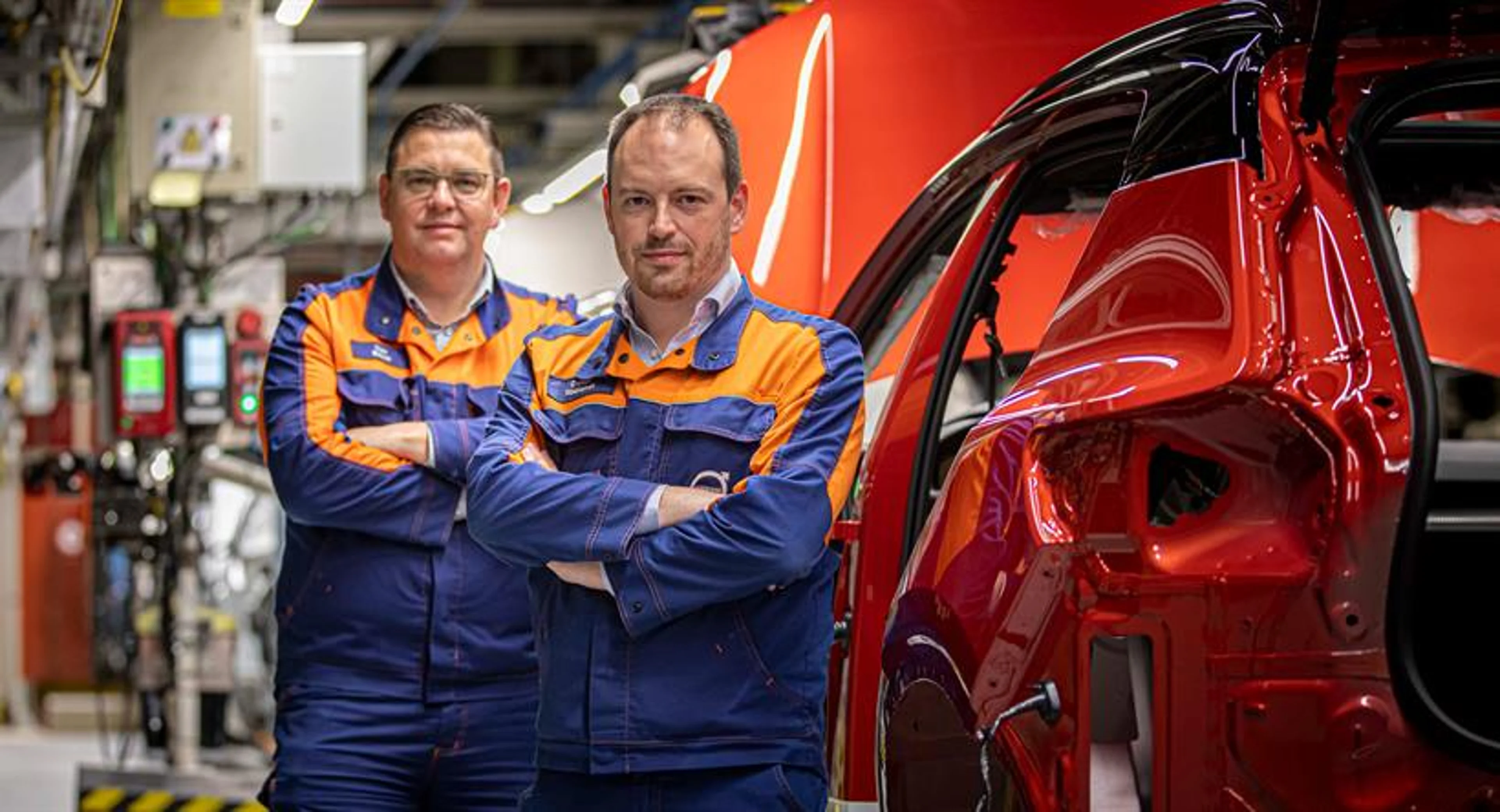 Volvo Cars staff Tom Buyse (left) and Dieter Roelandt standing by the production line at the Volvo Cars Ghent plant in Belgium.