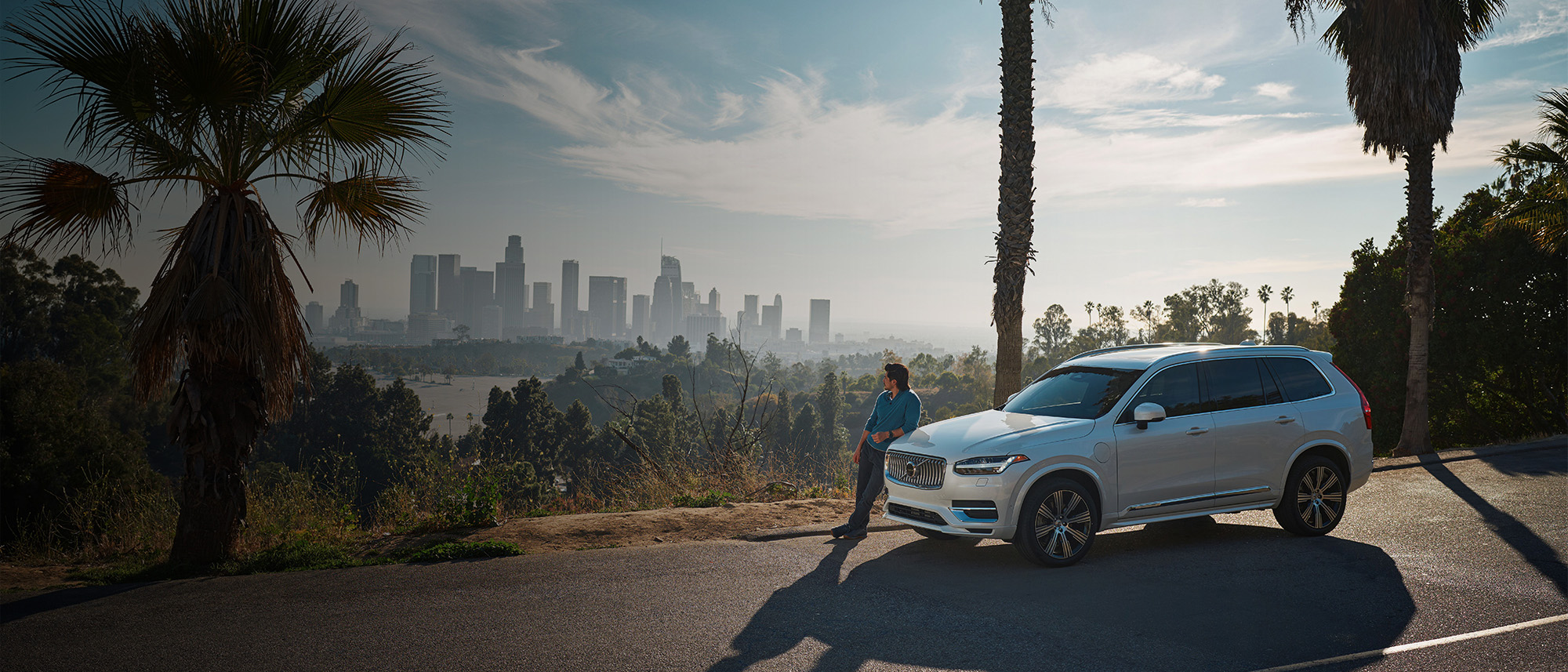 Volvo XC90 Recharge plug-in hybrid parked in front of scenic background 