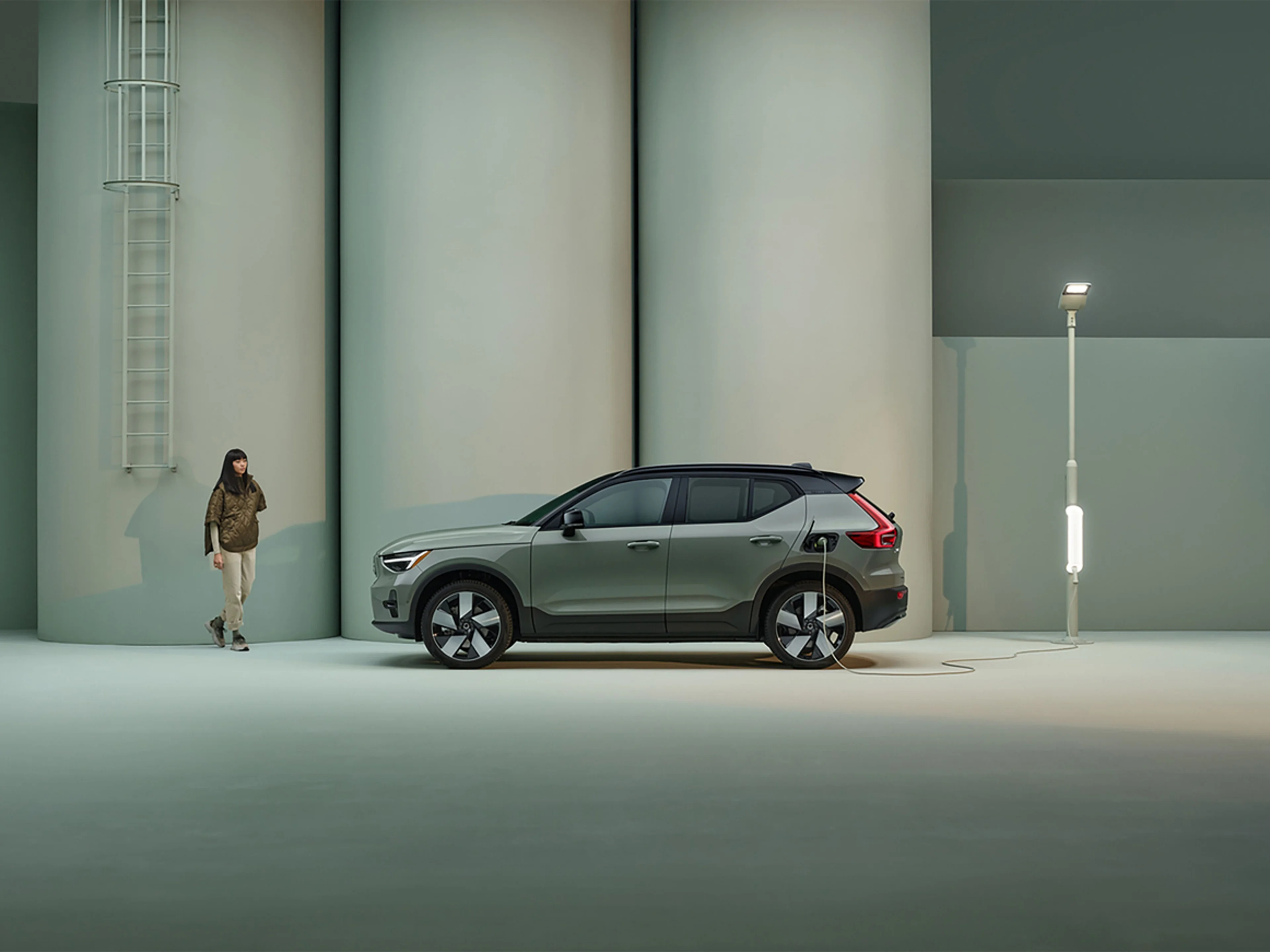 Electric Car Charging Point on the Road - Woman walking by an electric car