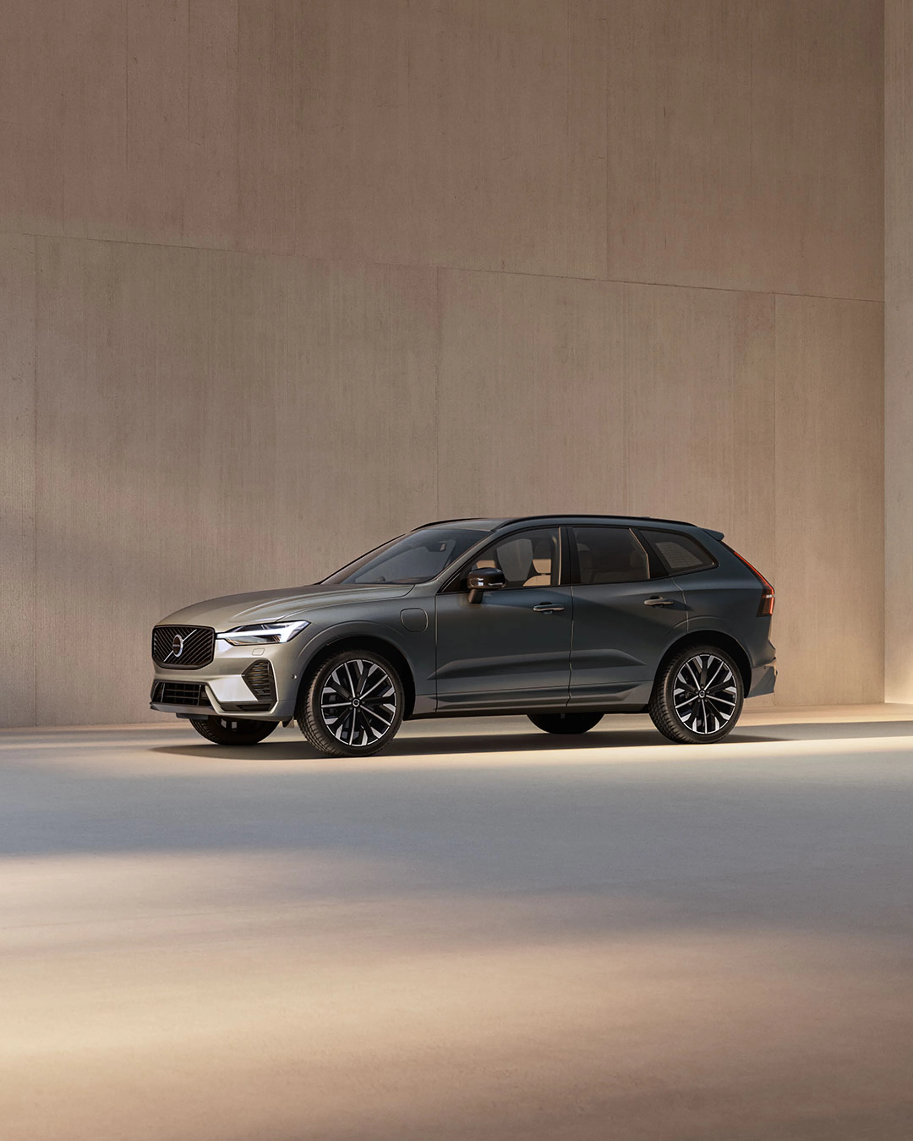 Front view of the fully electric Volvo EX90 SUV in Vapour Grey charging.