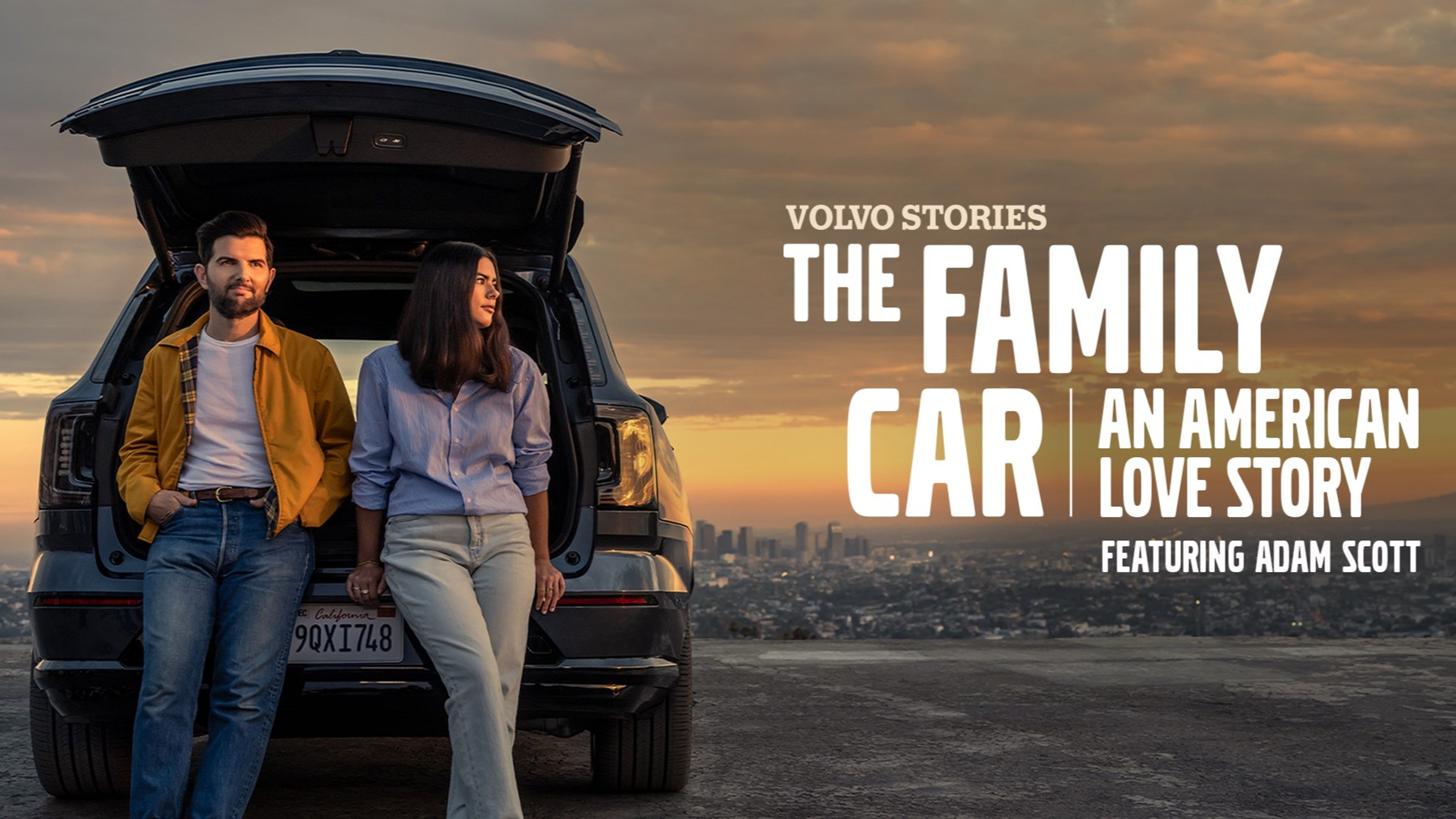 Man and woman standing near Volvo EX90