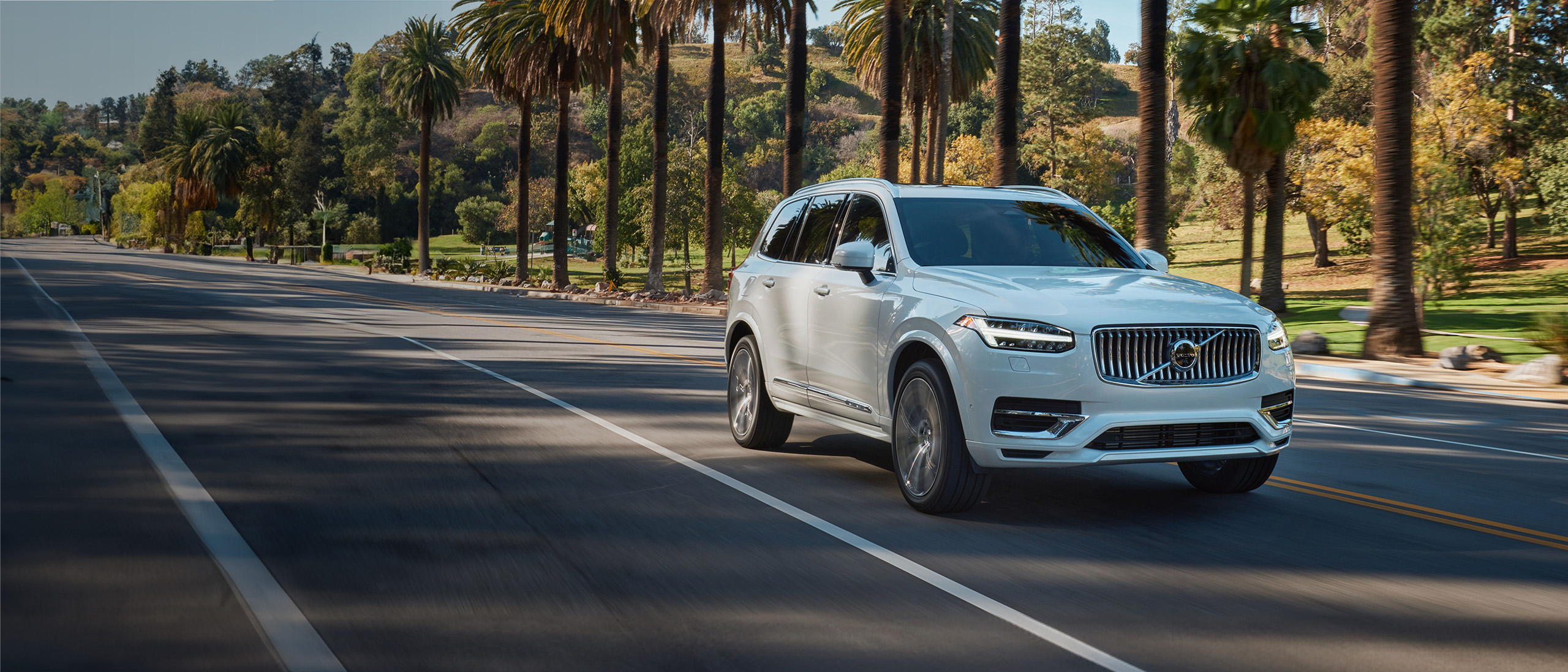 Volvo XC90 plug-in hybrid driving on scenic road