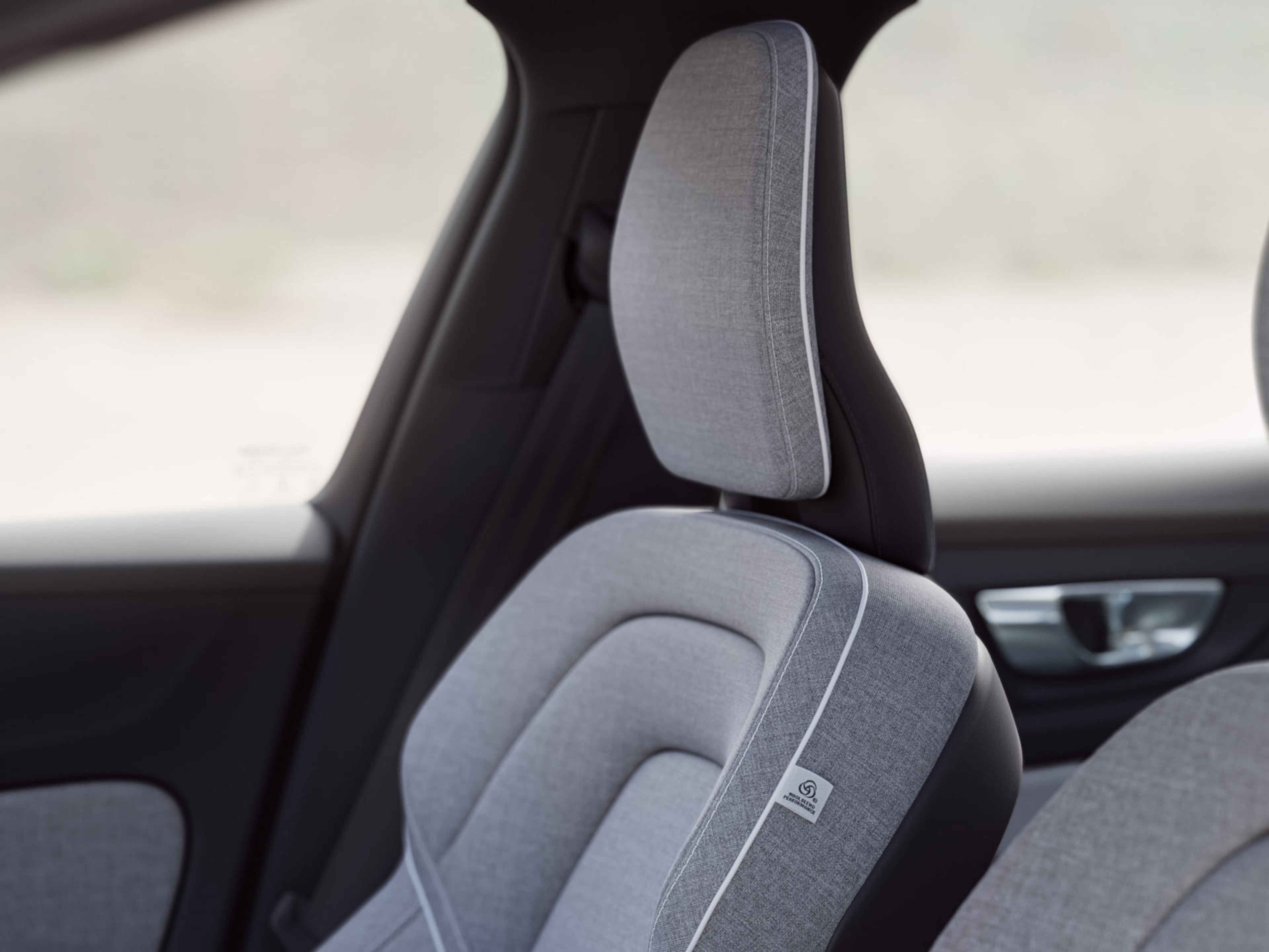 천으로 덮힌 Volvo 세단의 인체공학적인 시트 클로즈업.