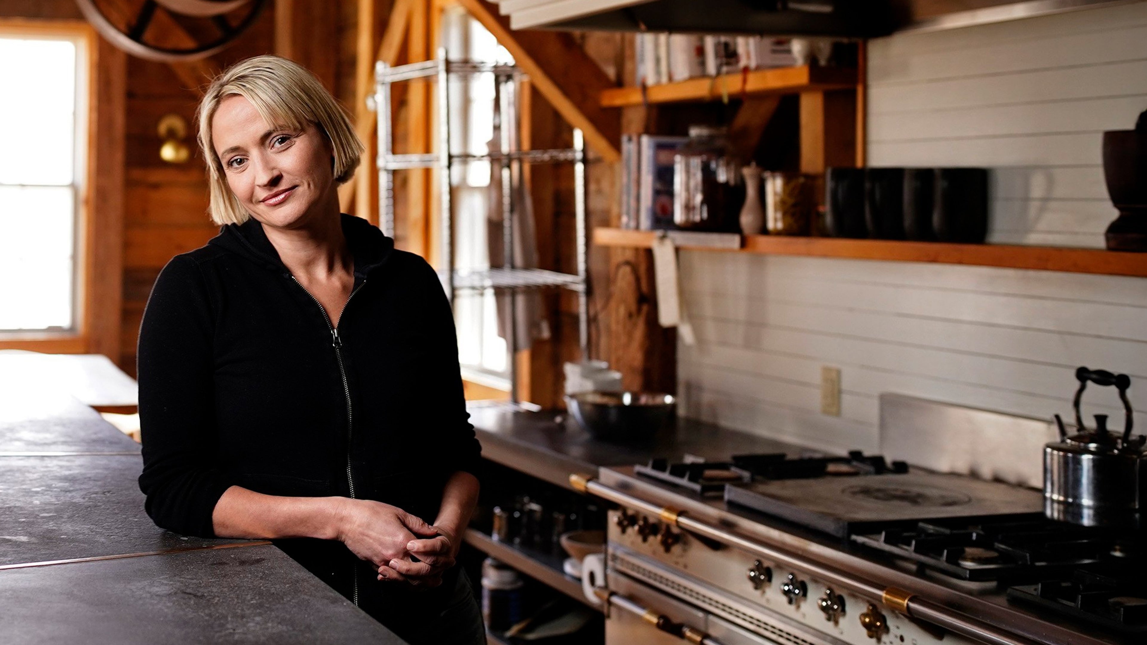 Woman standing in kitchen facing the camera