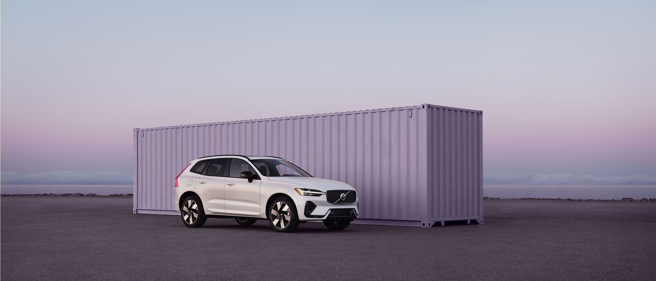 Volvo XC60 plug-in hybrid parked in front of purple background
