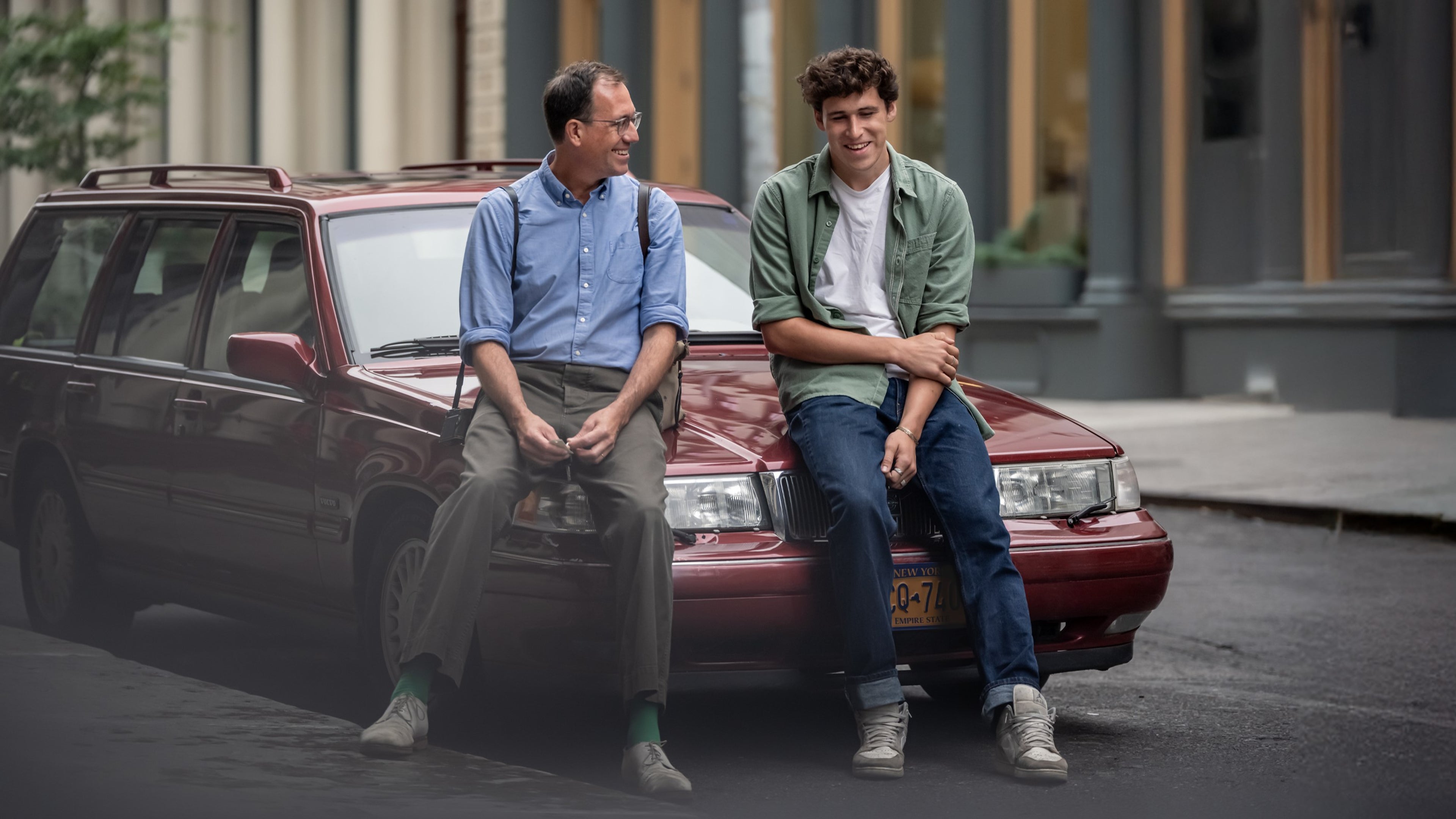 Two men standing near classic Volvo wagon