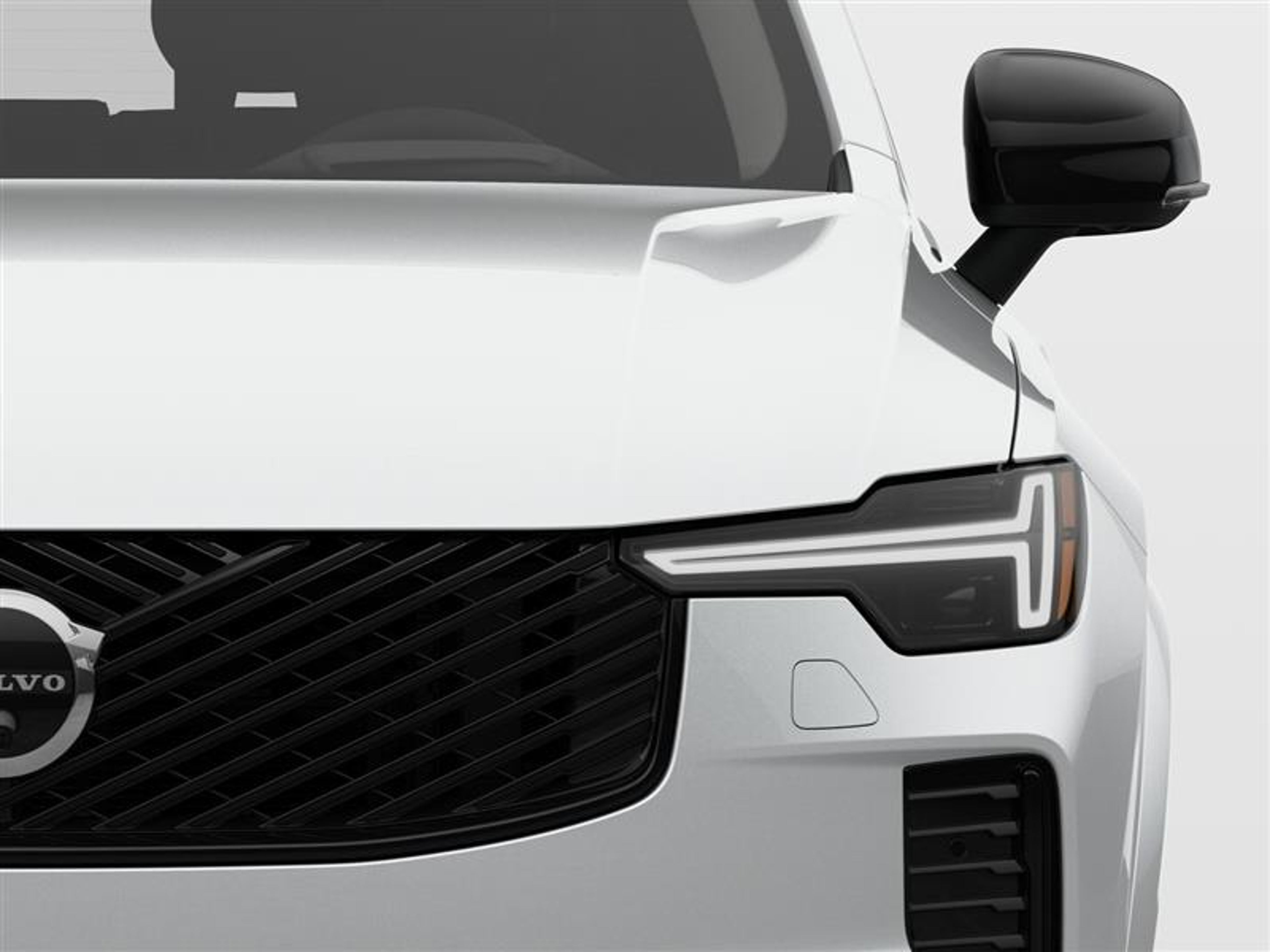 Front close up view of a plug-in hybrid Volvo car with 
a close up on the steel grille and sleek headlights.
