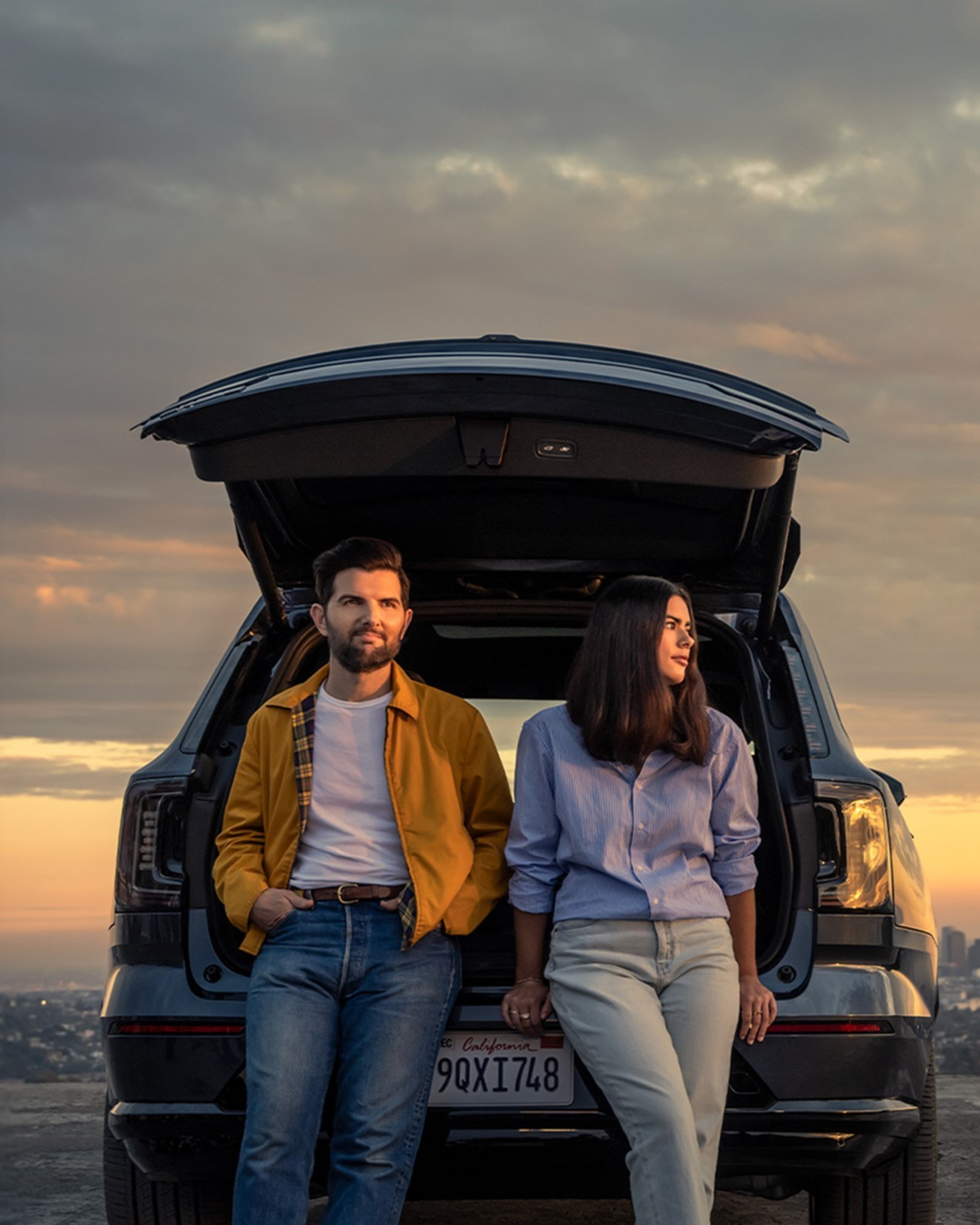 Volvo Stories - Adam Scott and his daughter standing near a Volvo EX90 electric SUV