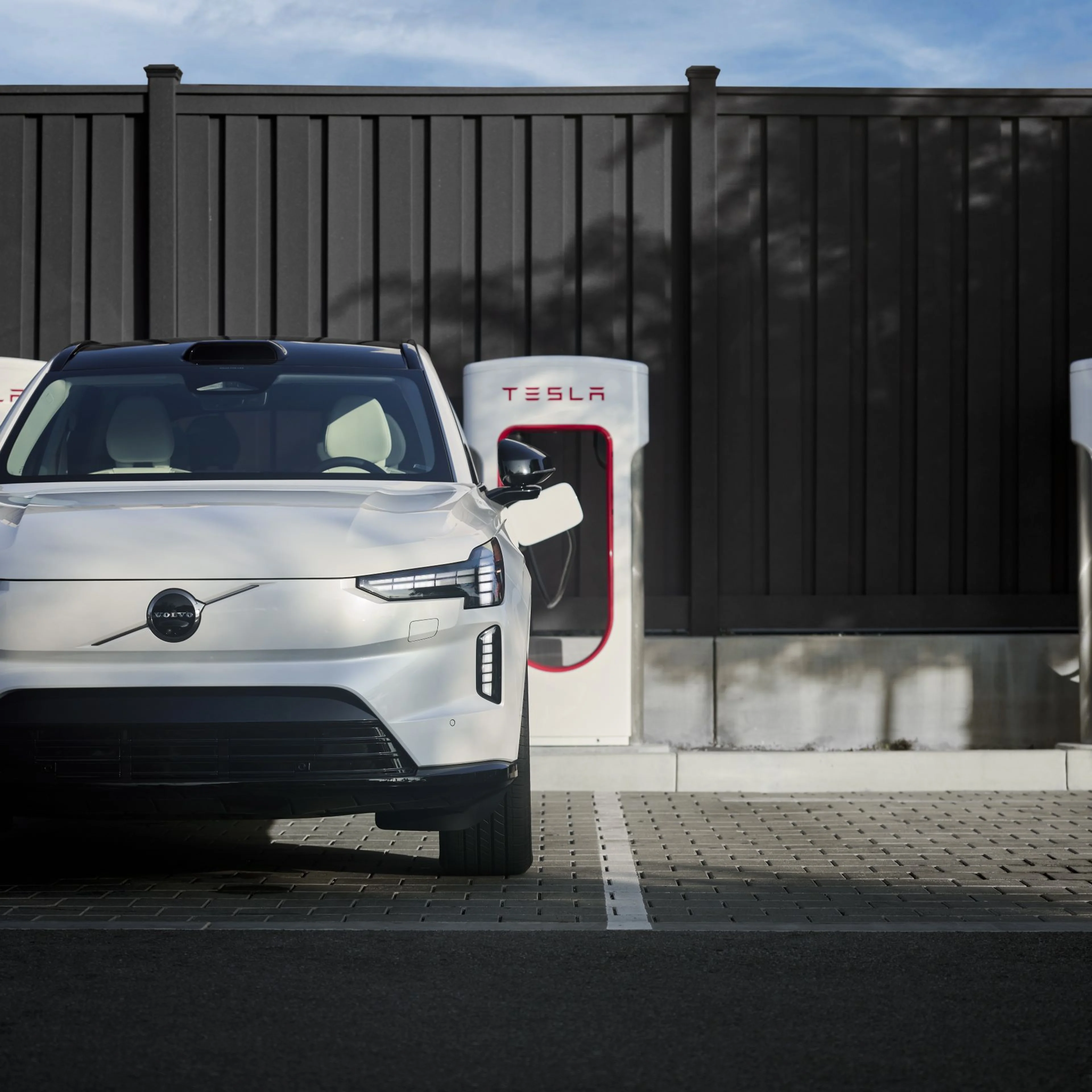Man charging Volvo SUV front view