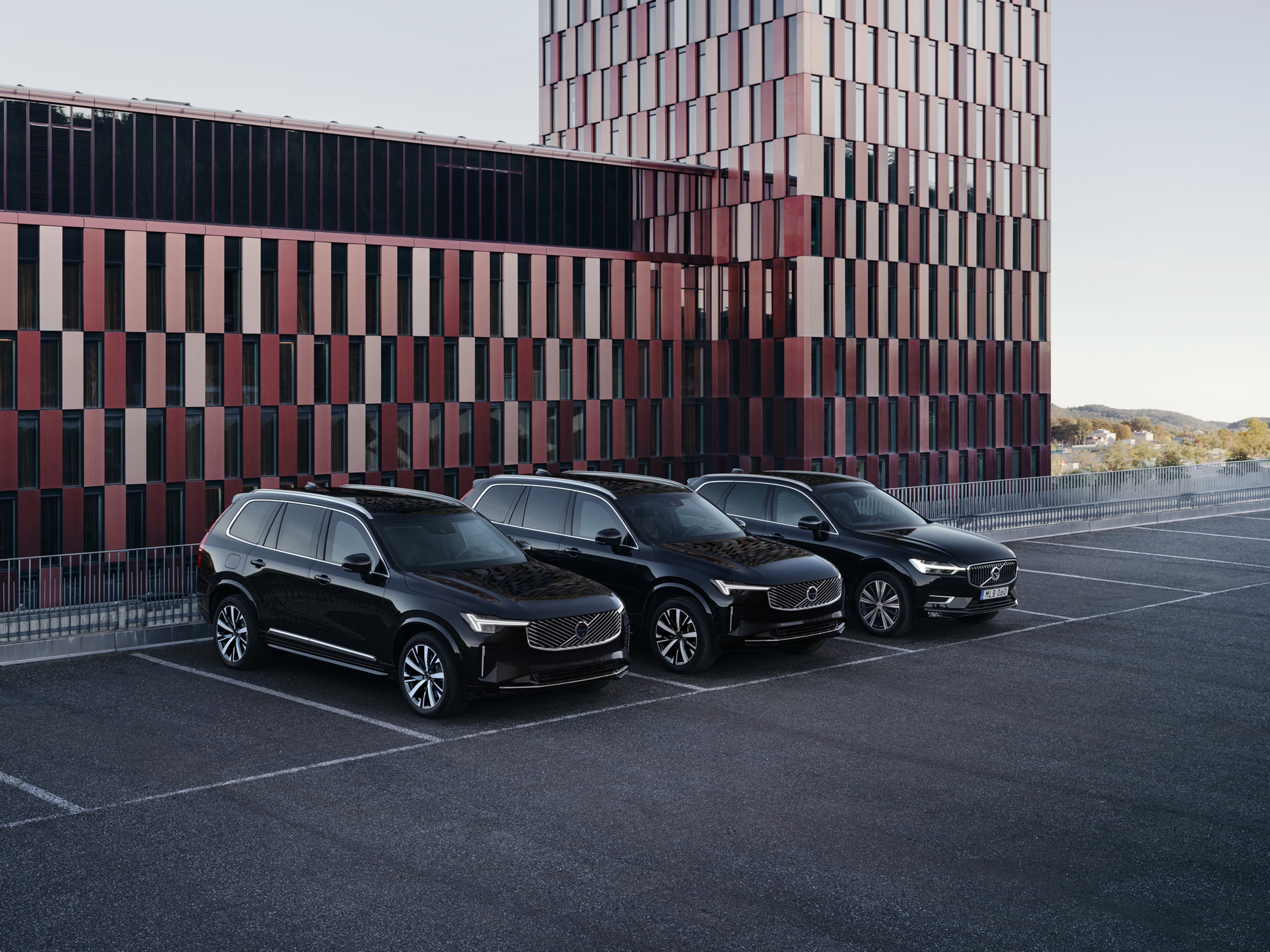 Two light-armoured Volvos parked.
