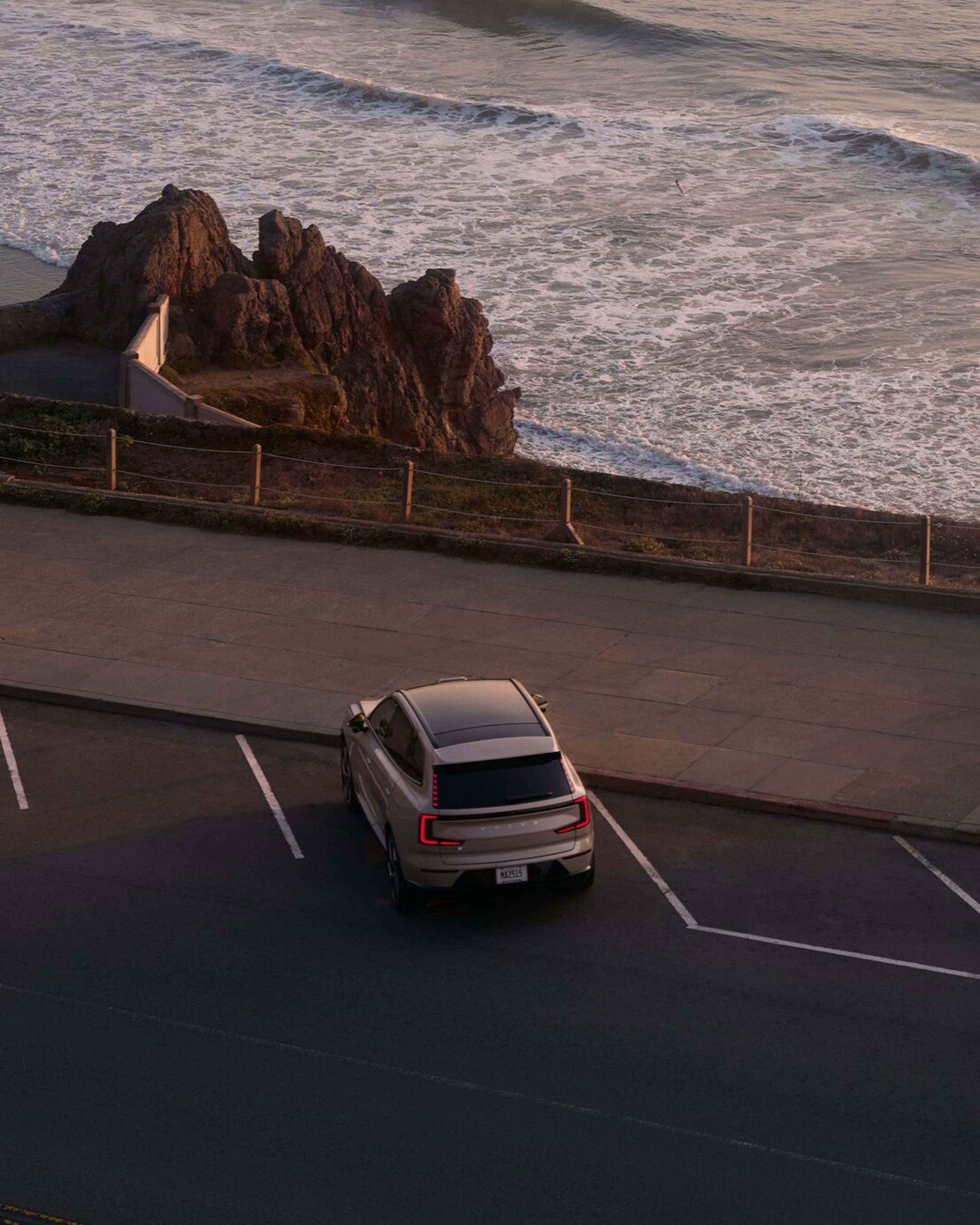 Volvo EX90 parked overlooking water