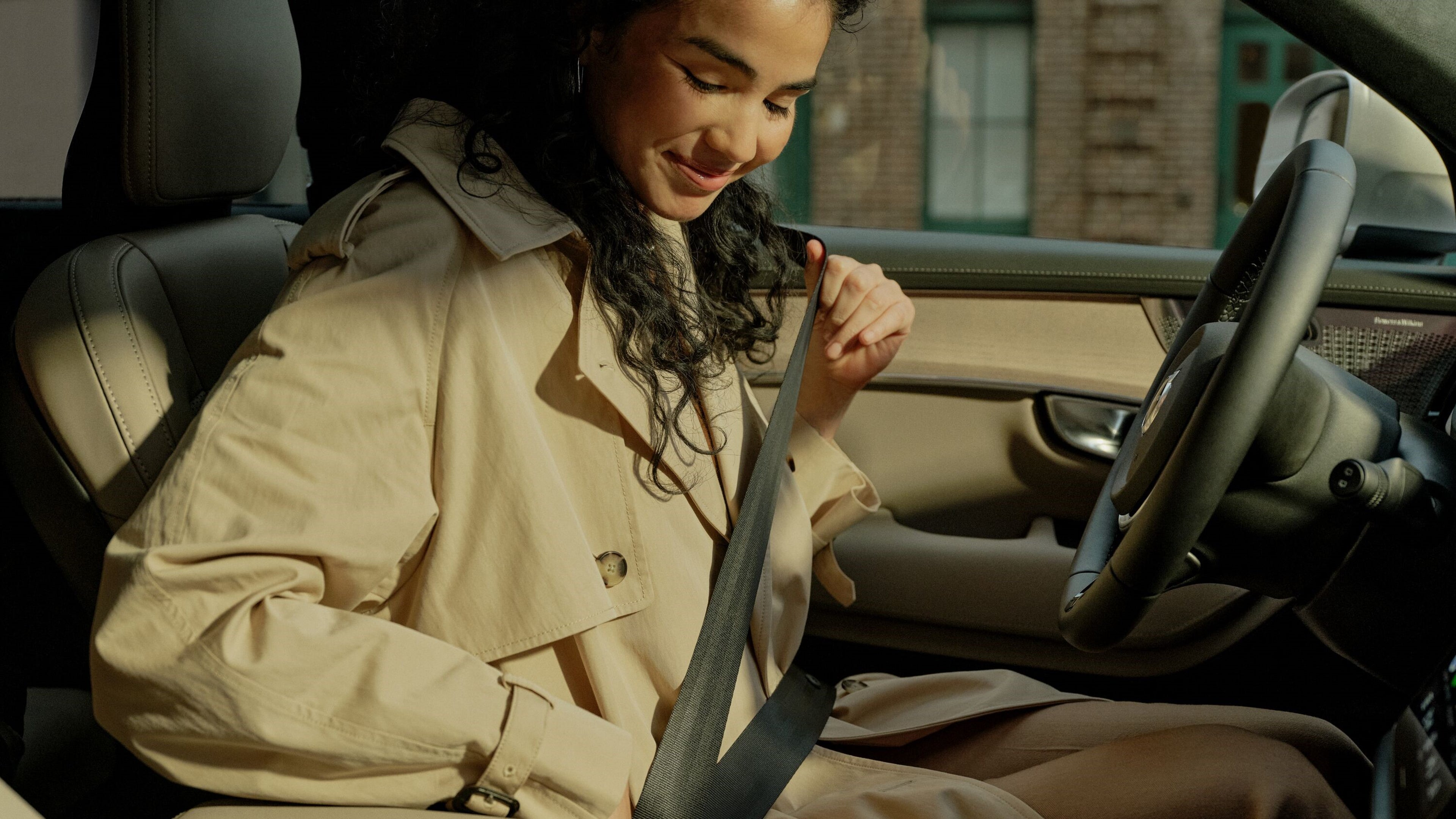 Woman buckling seat belt in a Volvo XC90 SUV