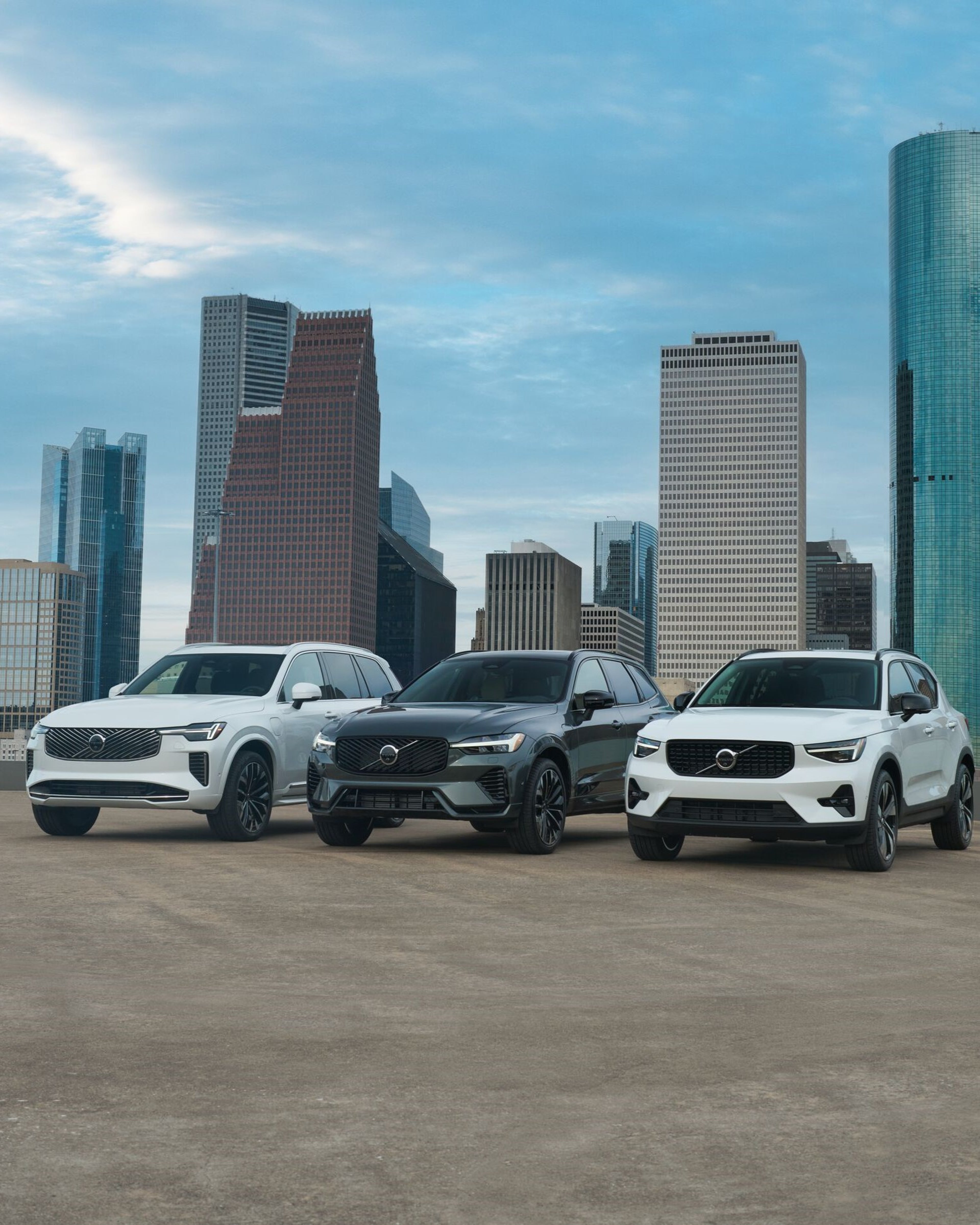 Volvo SUV Range parked in front of city