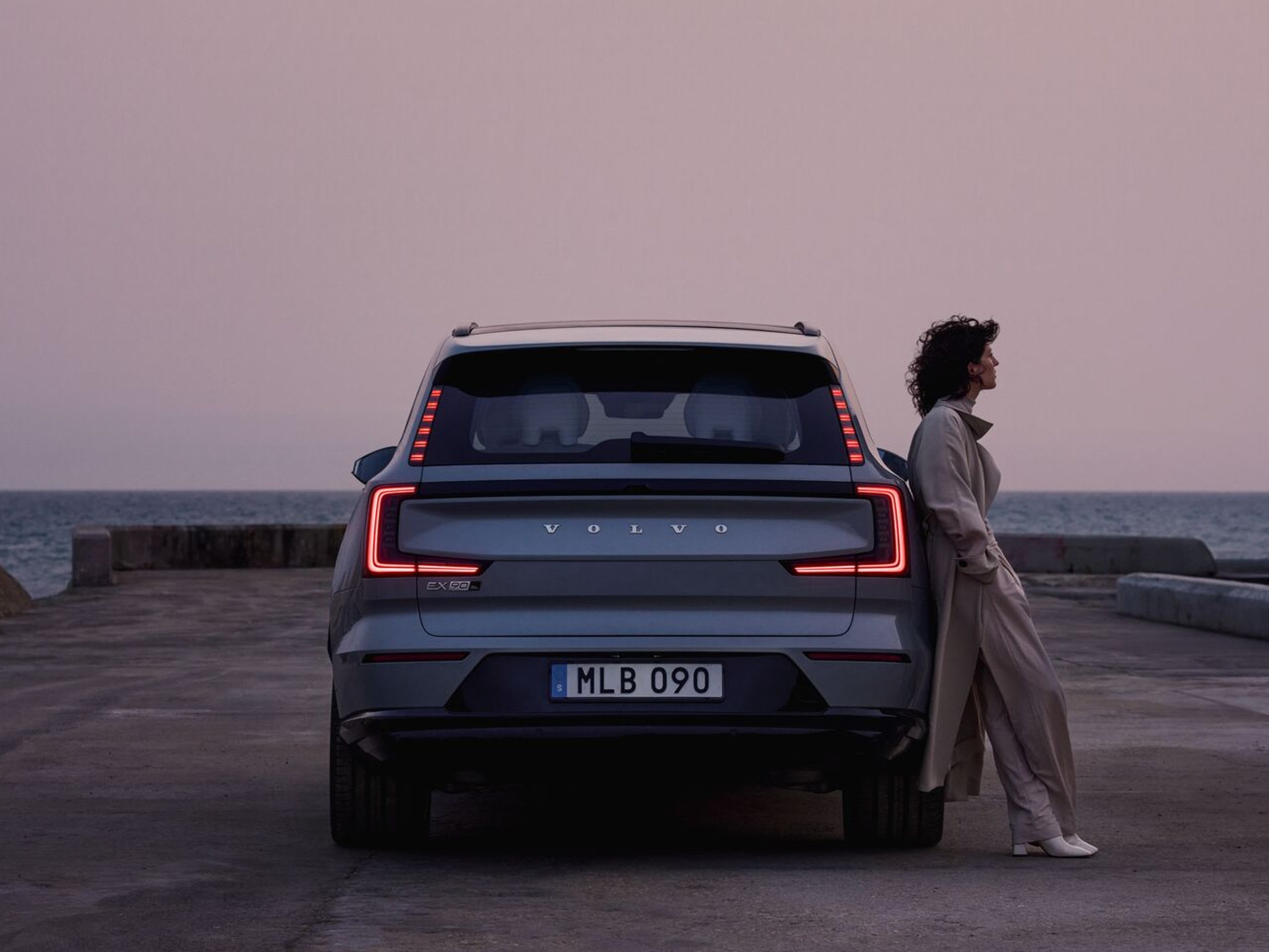 Two people inside a roof tent on a Volvo EX30