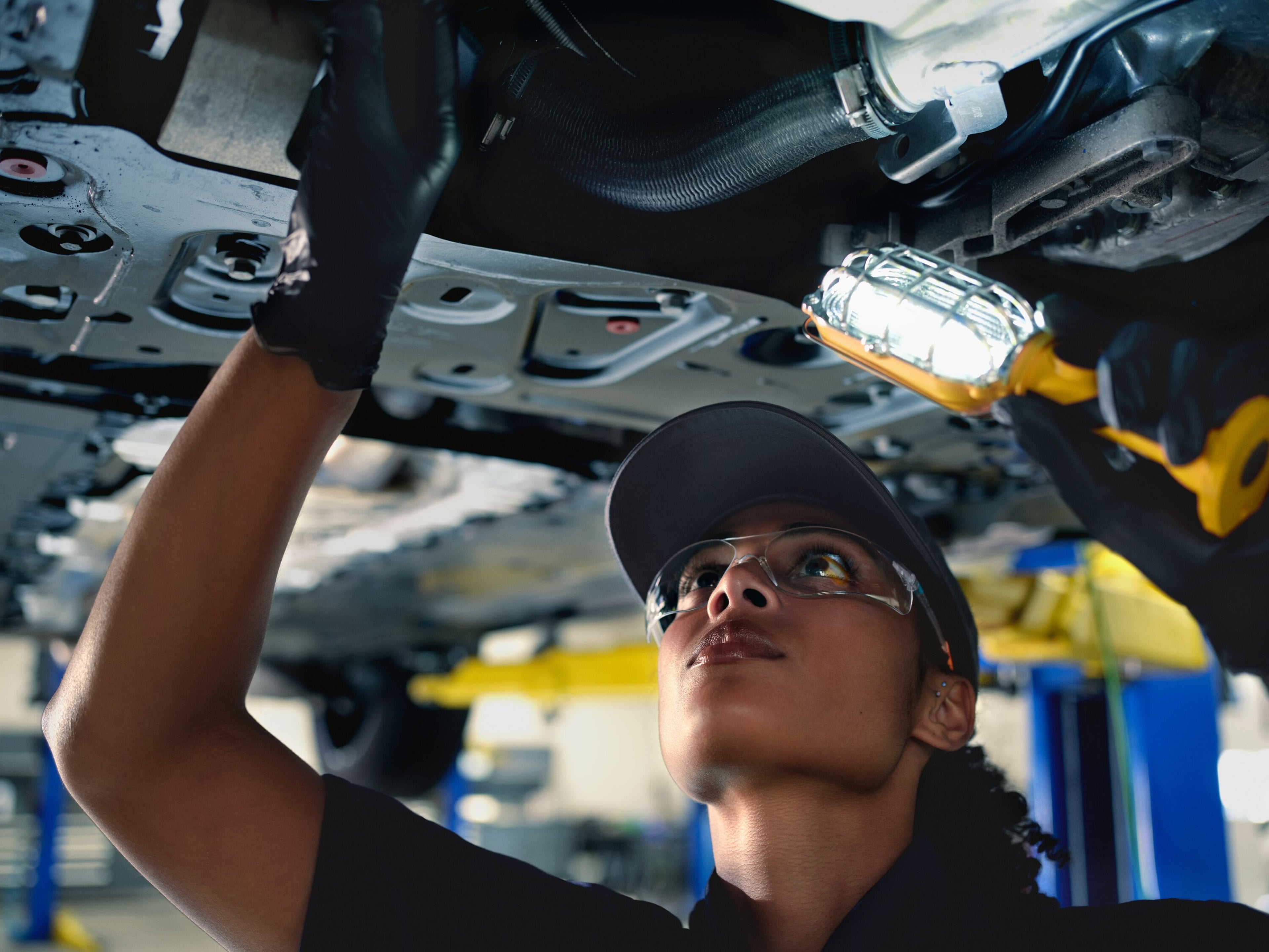 Technician working under Volvo car
