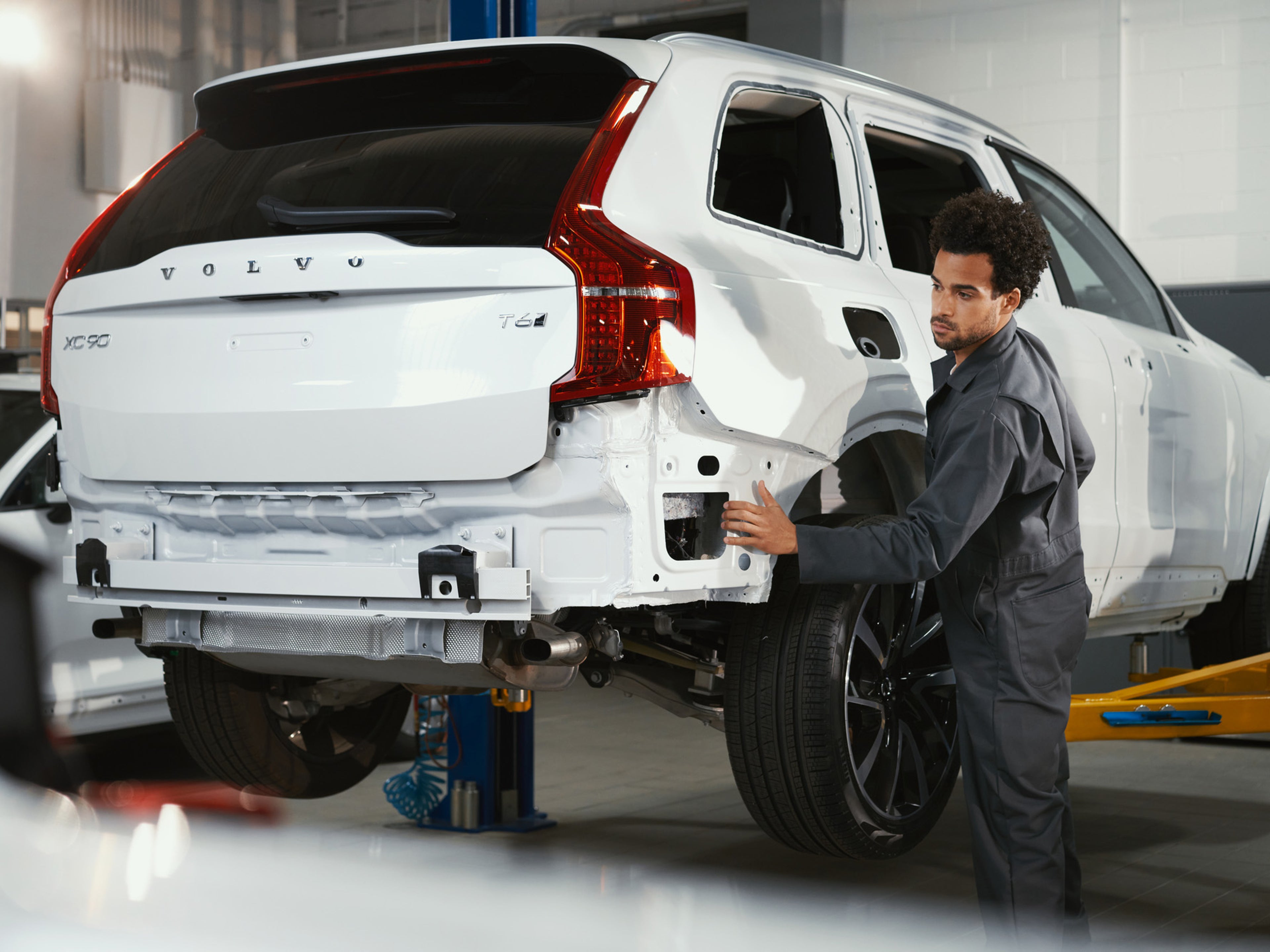 Certified Collision technician repairing rear of a Volvo XC90