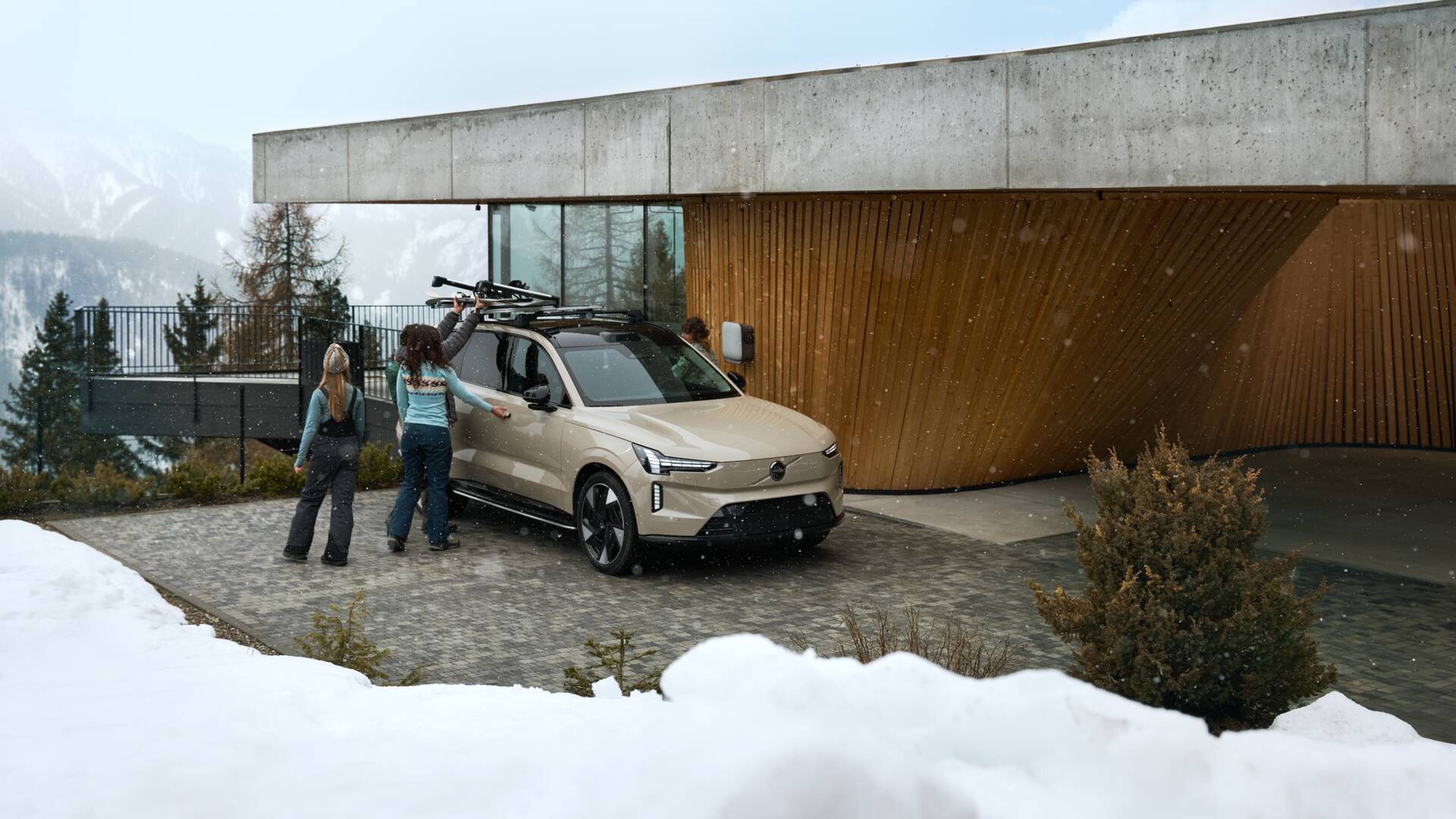 Our EX90 in Sand dune parked at a house on a winter snow day