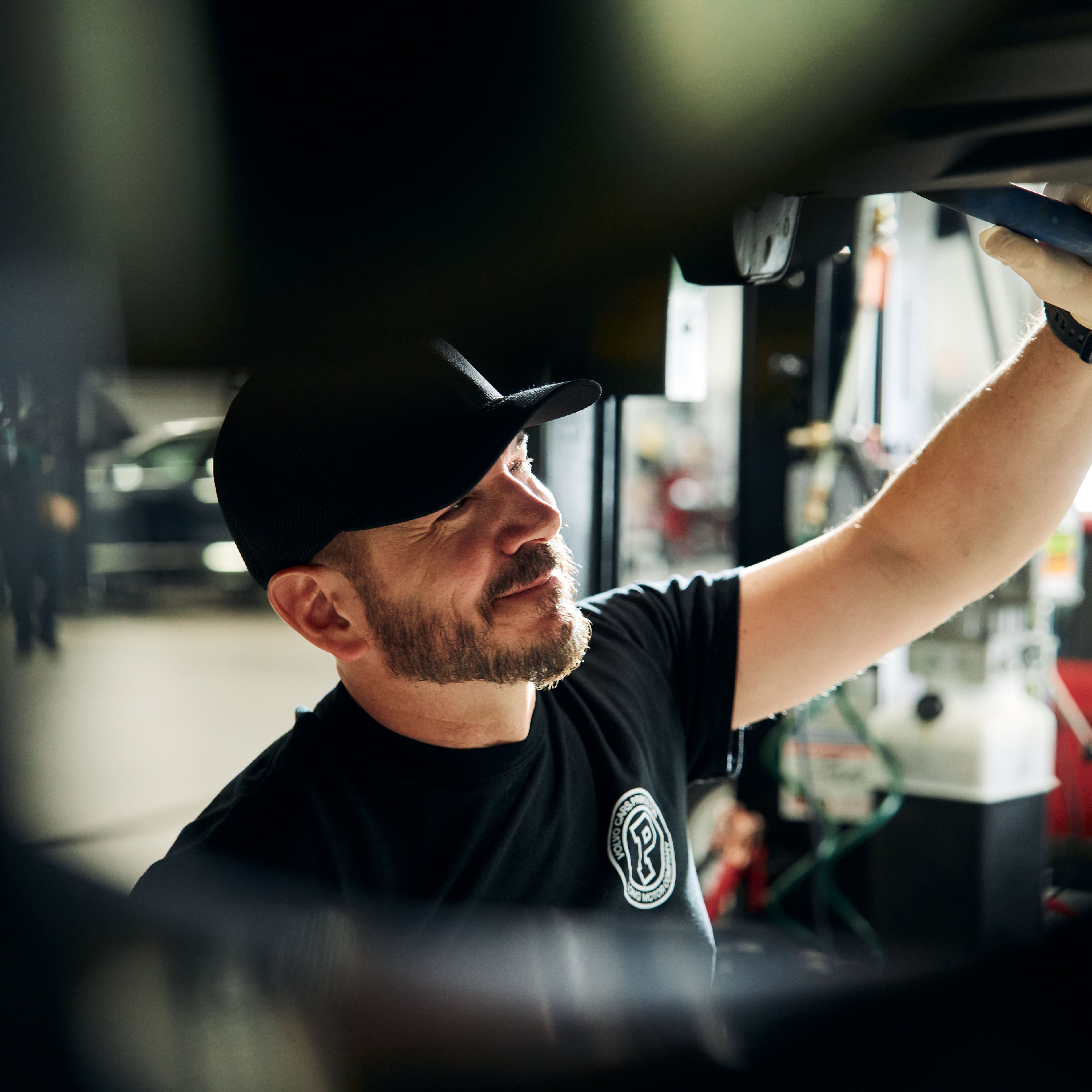 Technician working under Volvo car