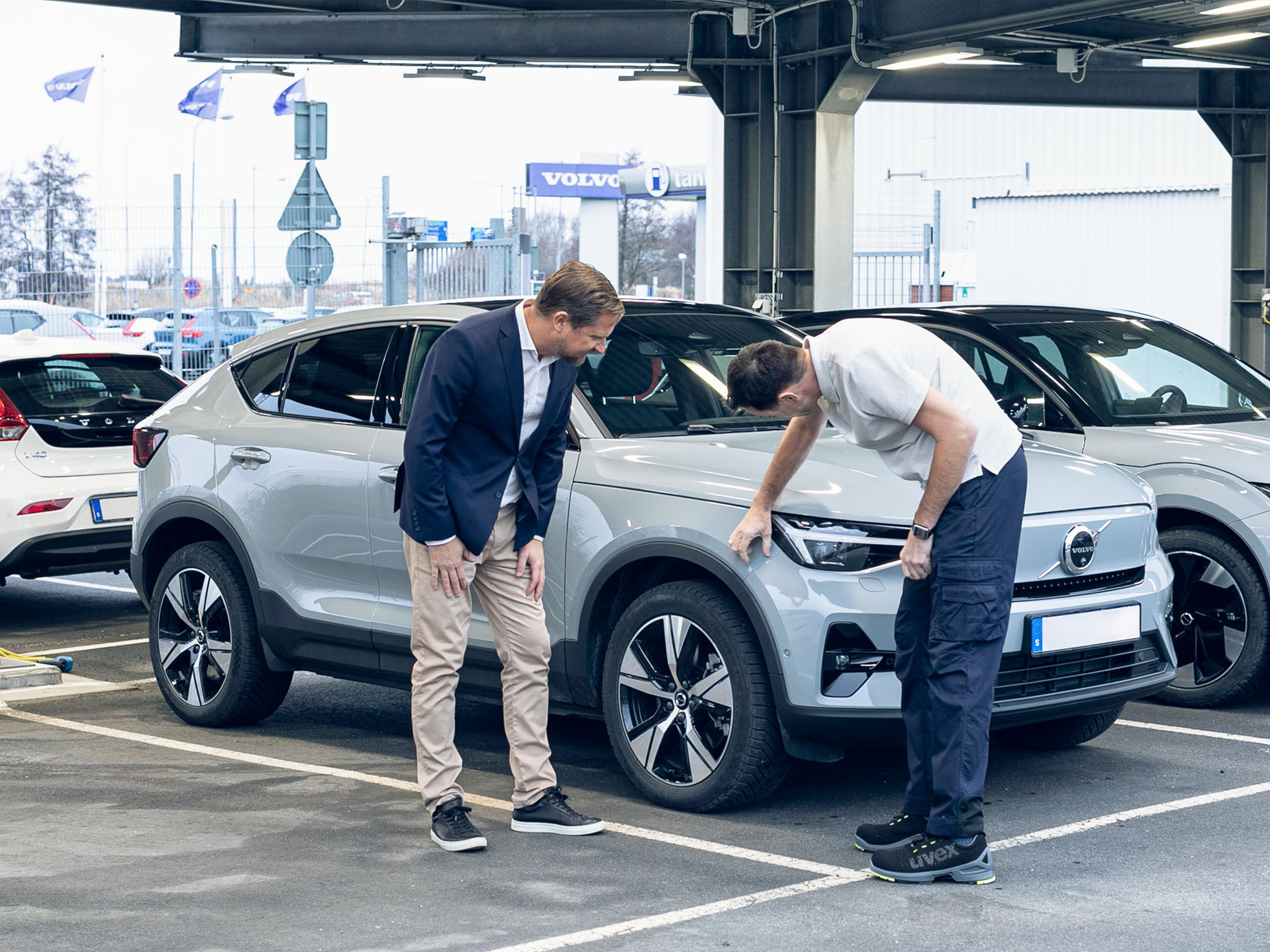 Dos personas revisando un vehículo Volvo haciendo una tasación