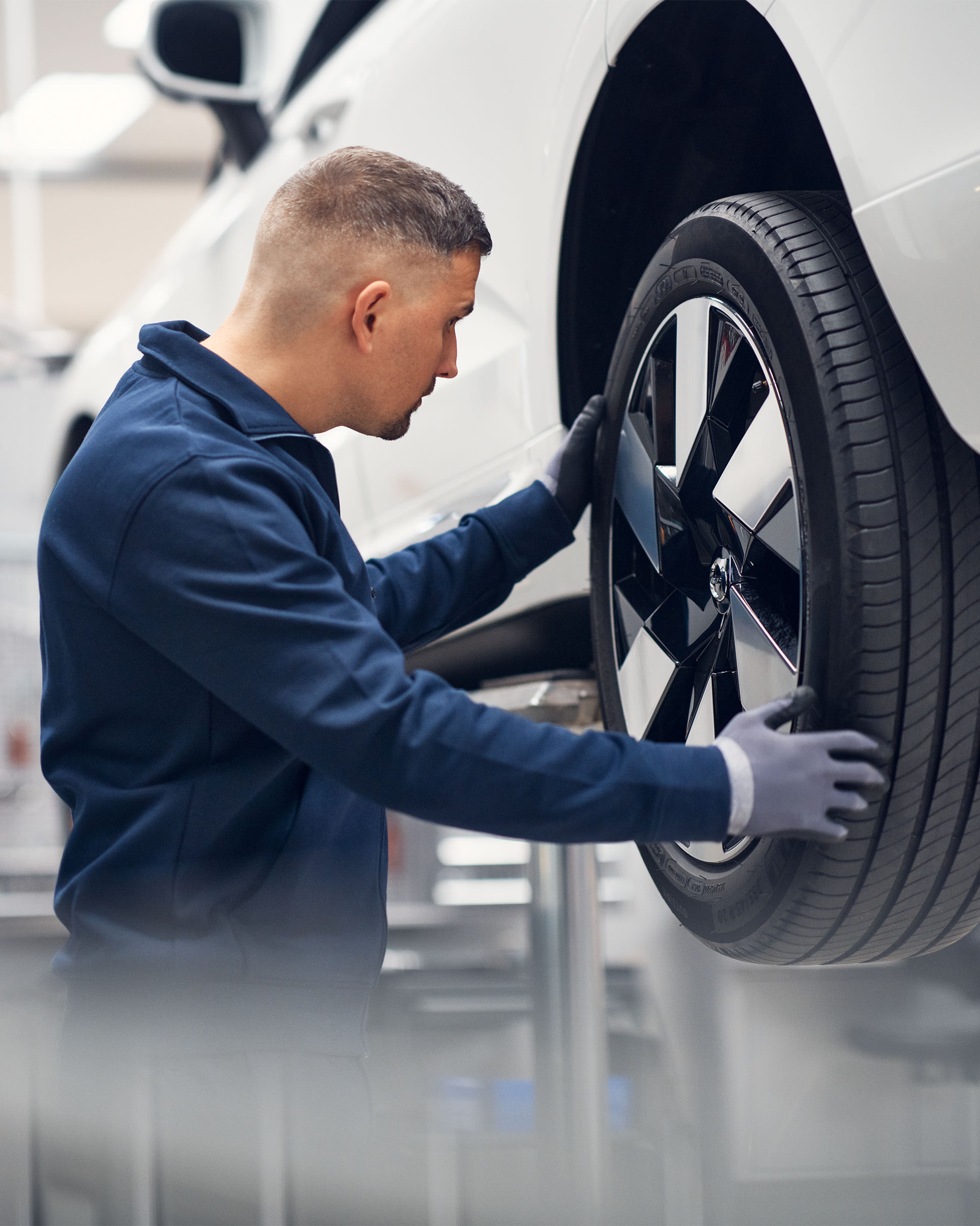 Volvo Genuine Tires - Mechanic installing a tire on a car