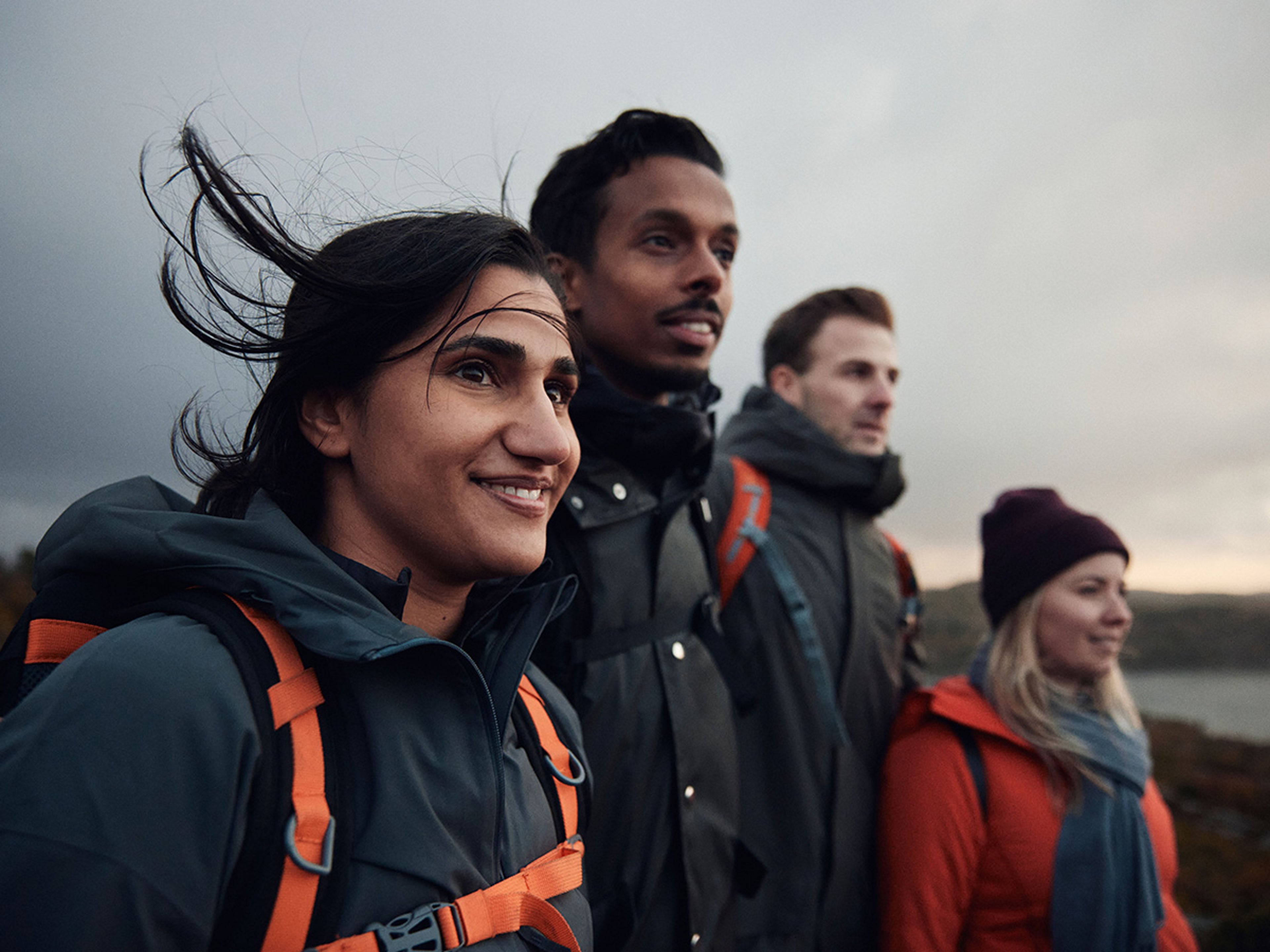 Een close-up medium shot van vier wandelaars die naar de verte kijken.