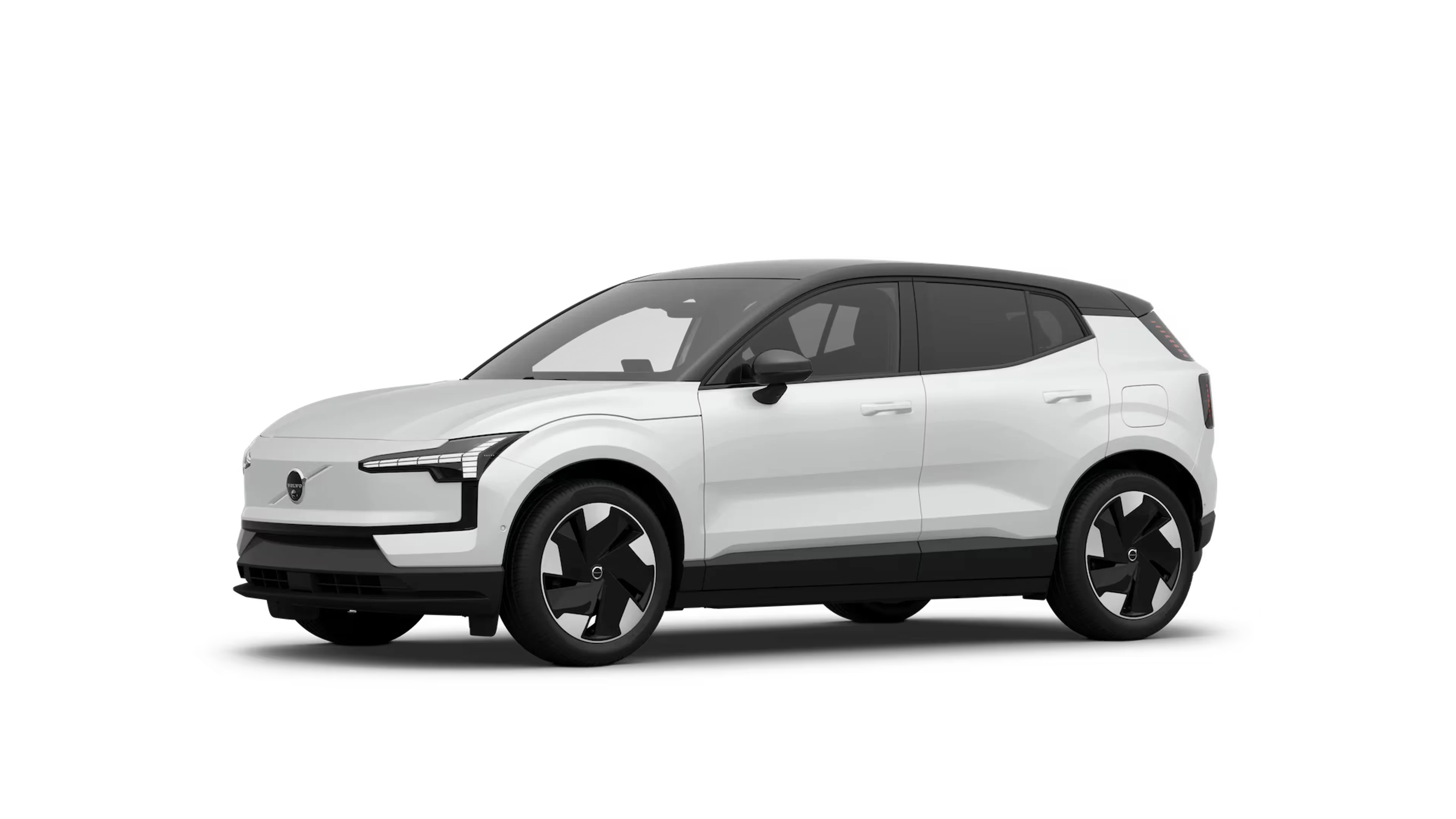 Elegant hvid VOLVO SUV med moderne design, skarpe LED-forlygter og sorte designdetaljer. Køretøjet er parkeret på en enkel grå baggrund.