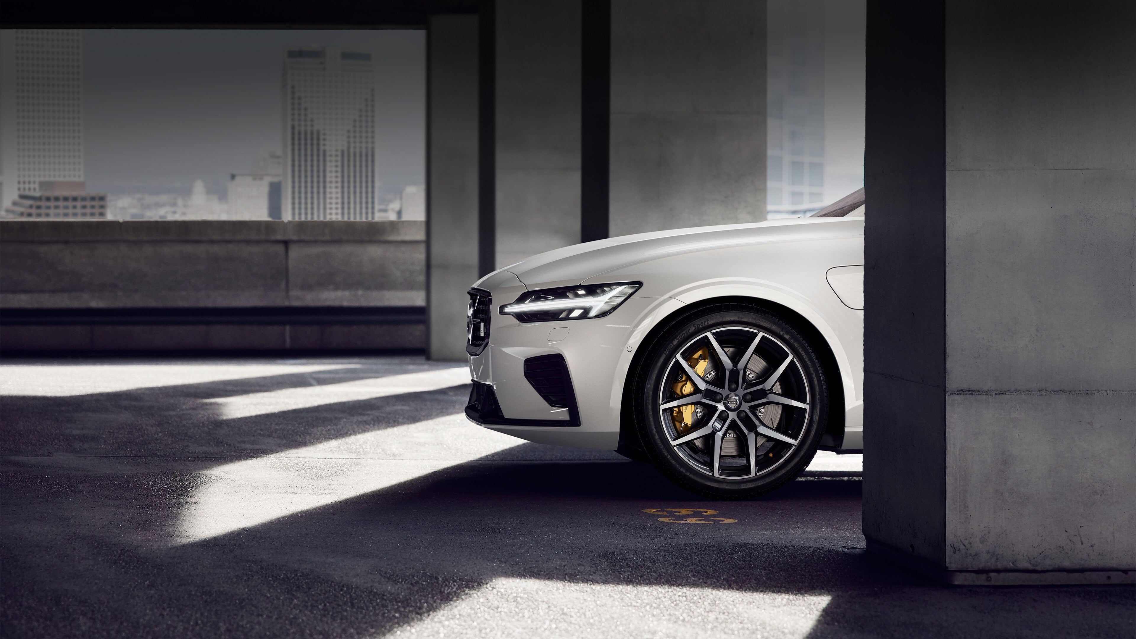 Hvit XC60 parkert i parkeringshus