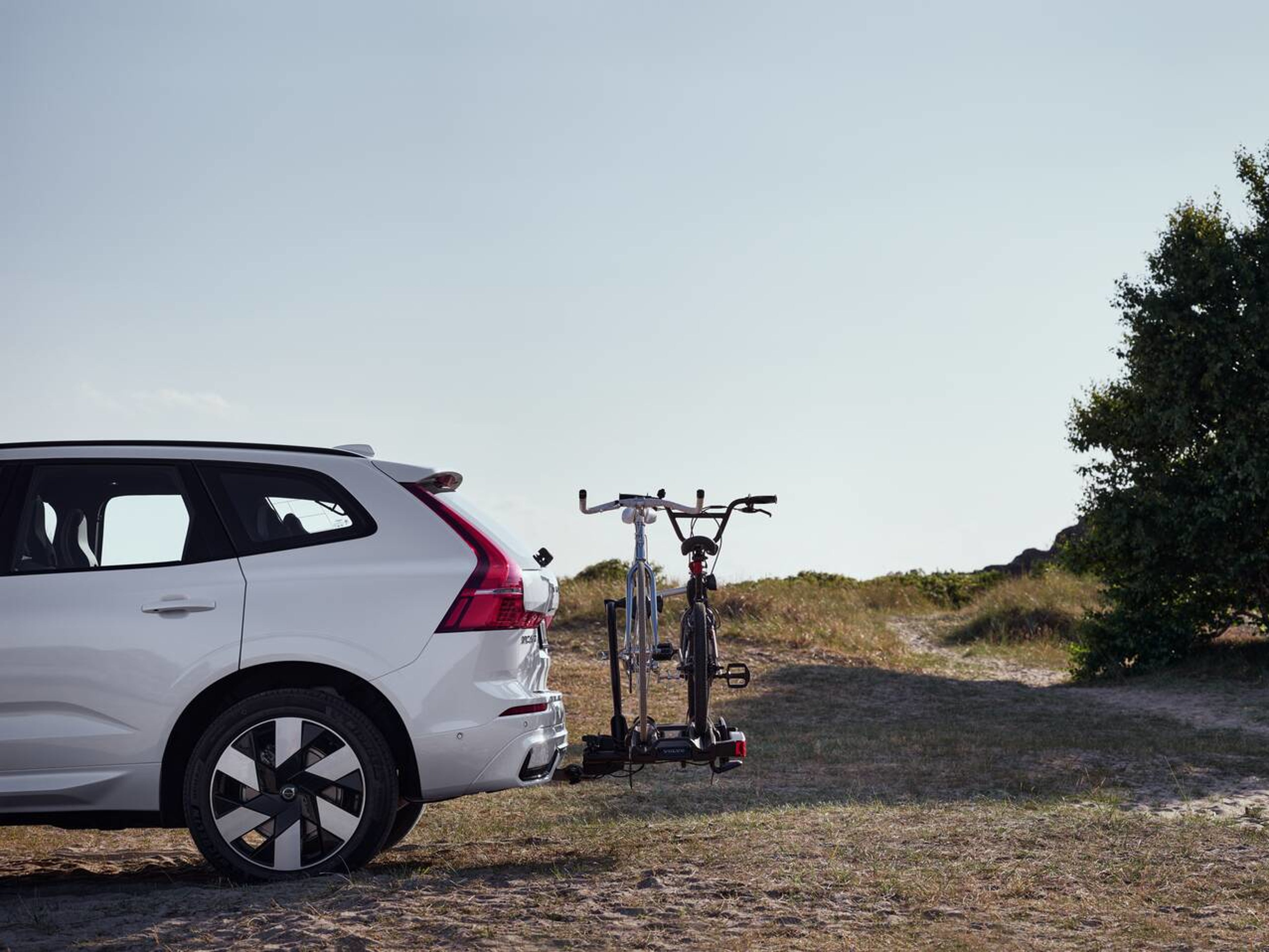 A Volvo car with a bike holder with a bicycle attached