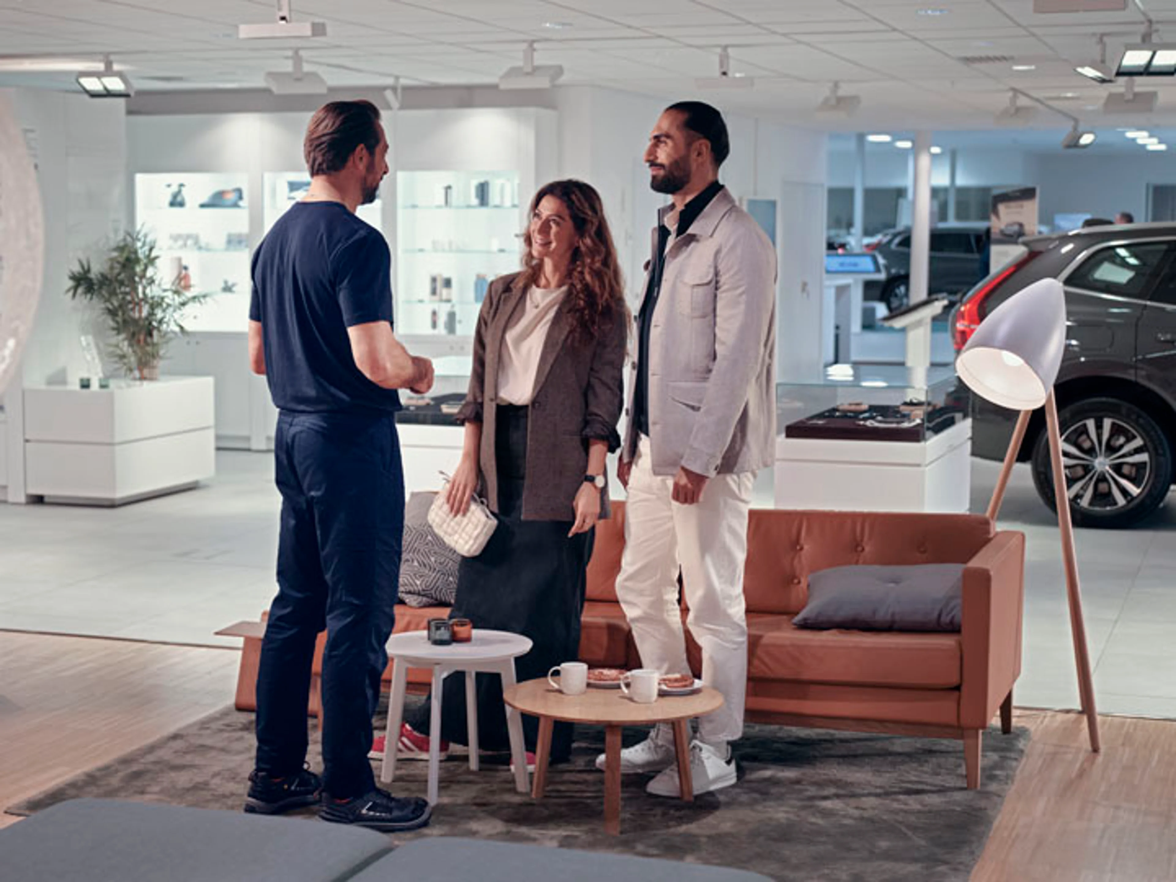 Una pareja conversando con un técnico en un taller o servicio oficial Volvo