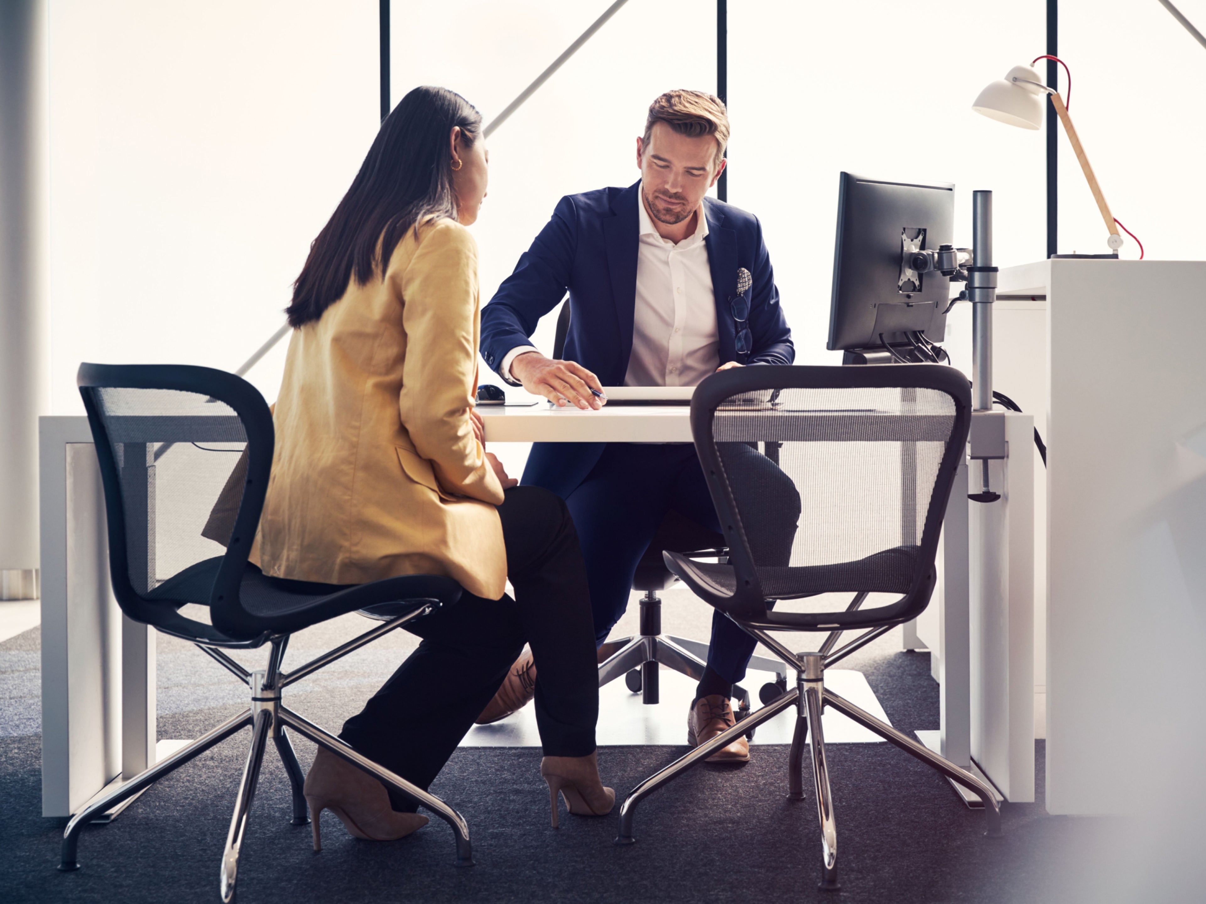 Un asistente atendiendo a una mujer en un centro de servicio.
