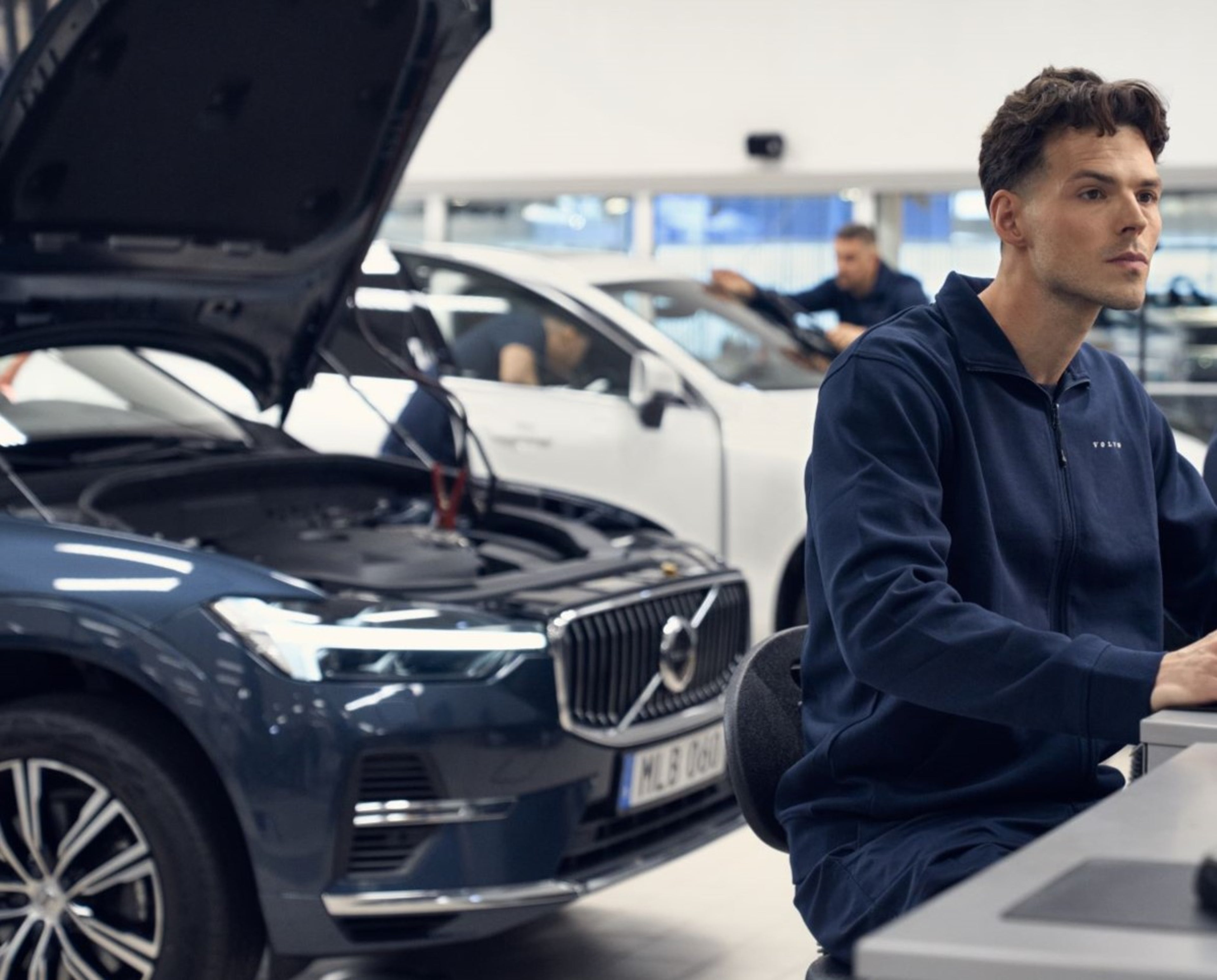 Volvo technician using computer to fix car