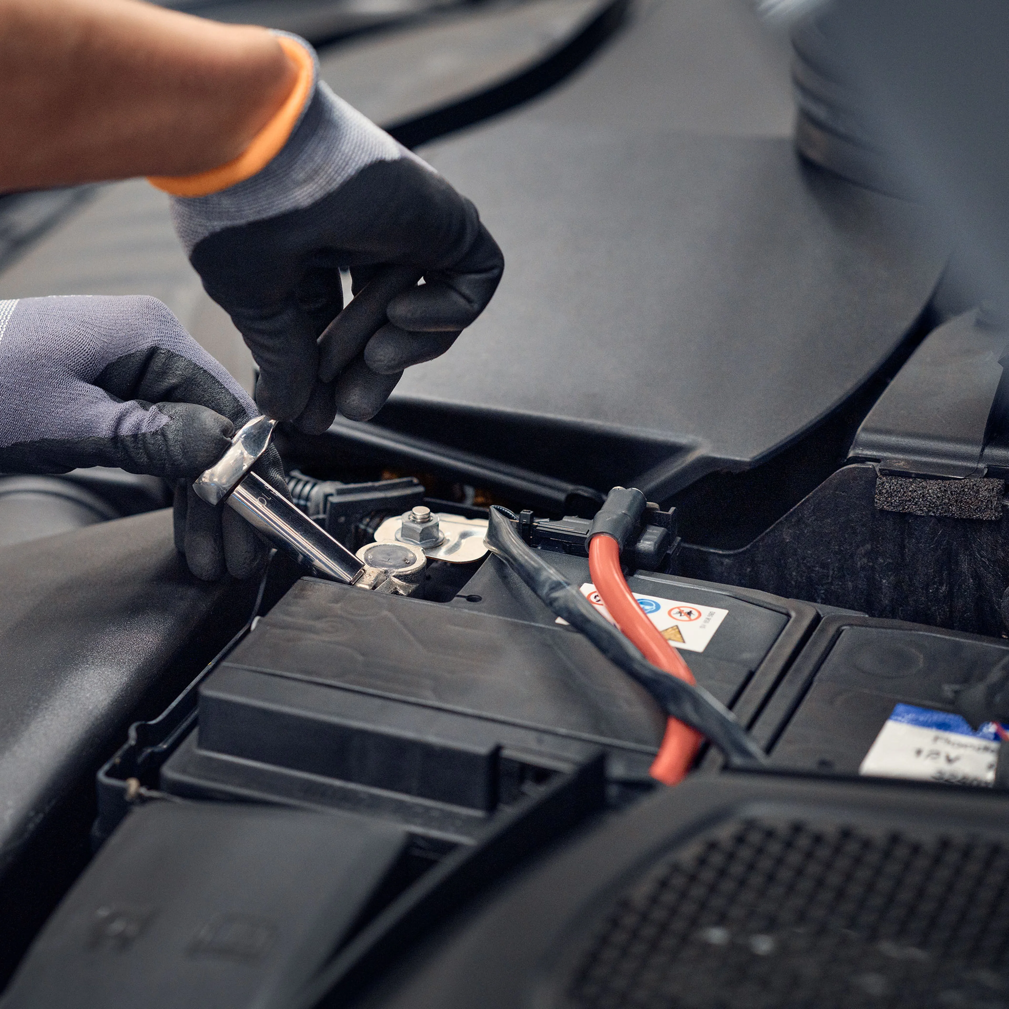 Omamekaanikko vaihtaa 12V akkua Volvo autoon.