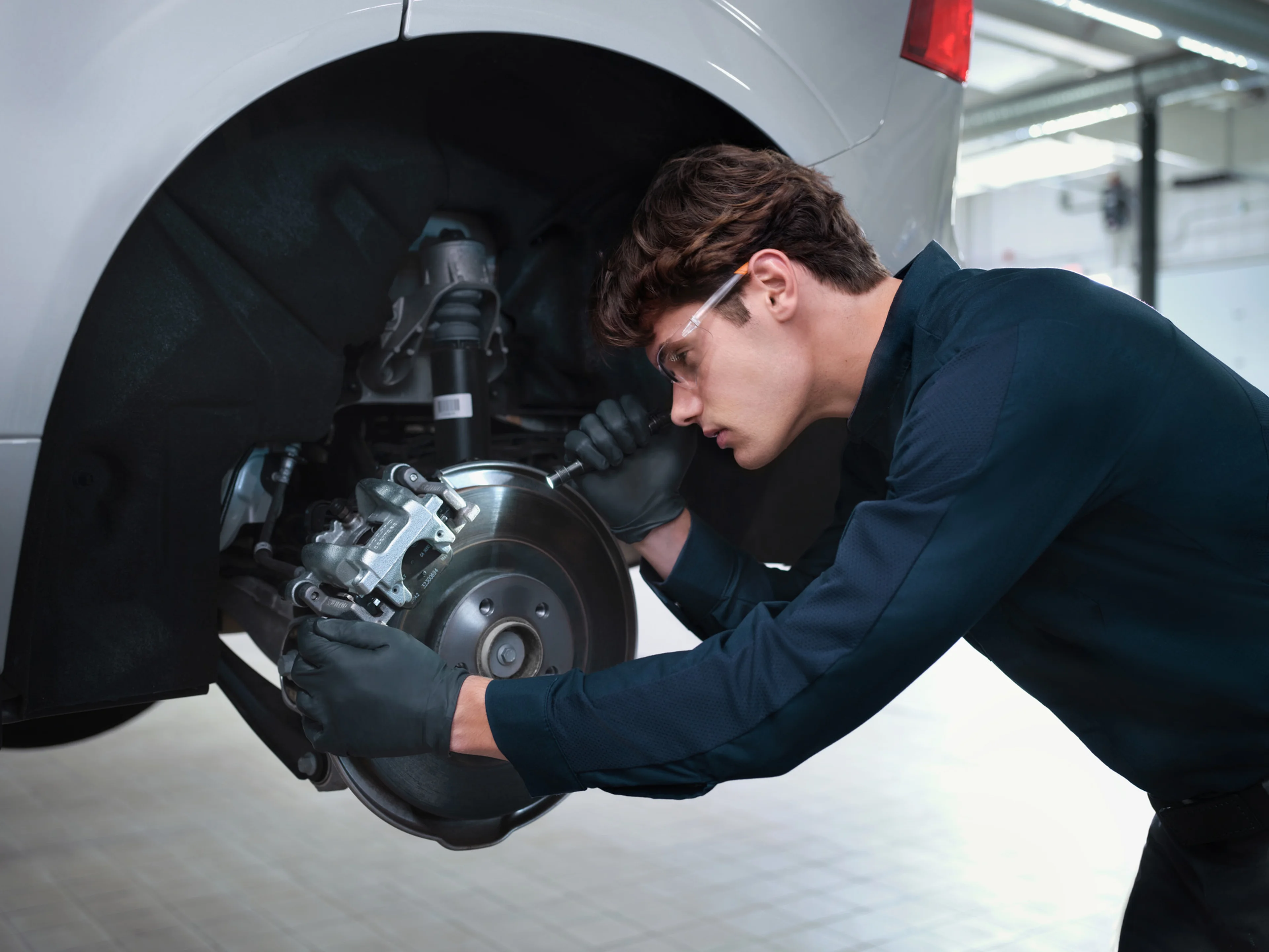 Volvo technician inspecting brake system